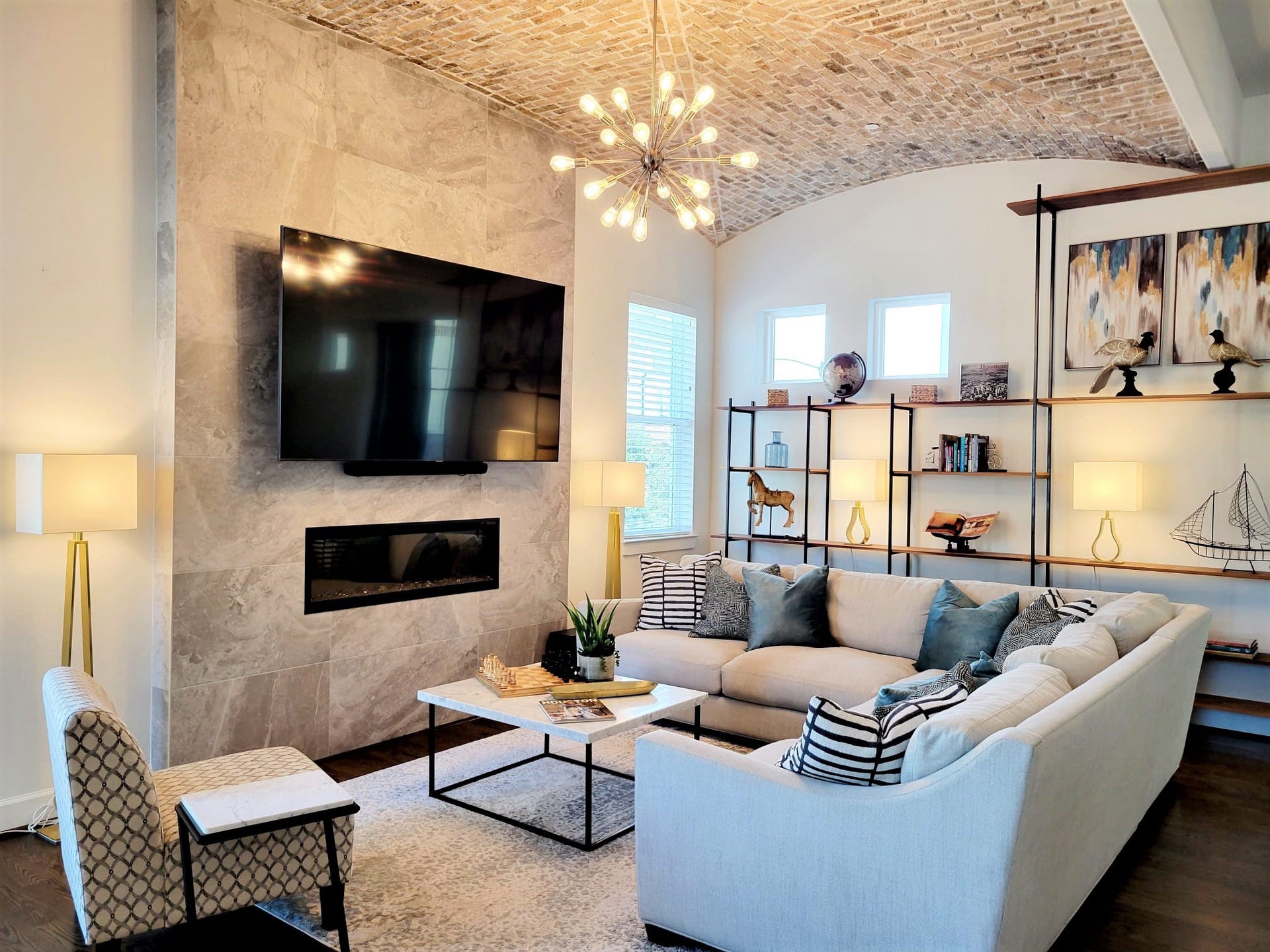 Cozy living room with an amazing brick ceiling and a fire place. Large TV with surround sound to enjoy