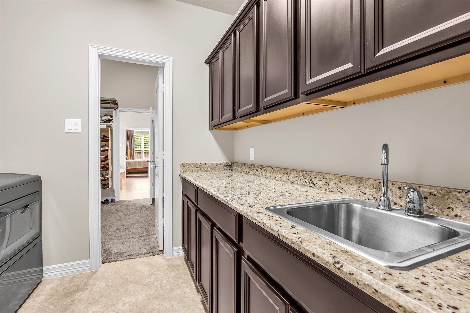 246 Hearthshire Circle, The Woodlands, TX 77354 Nice sized utility room with storage cabinets, extra counter space and sink can access through primary closet or from hallway