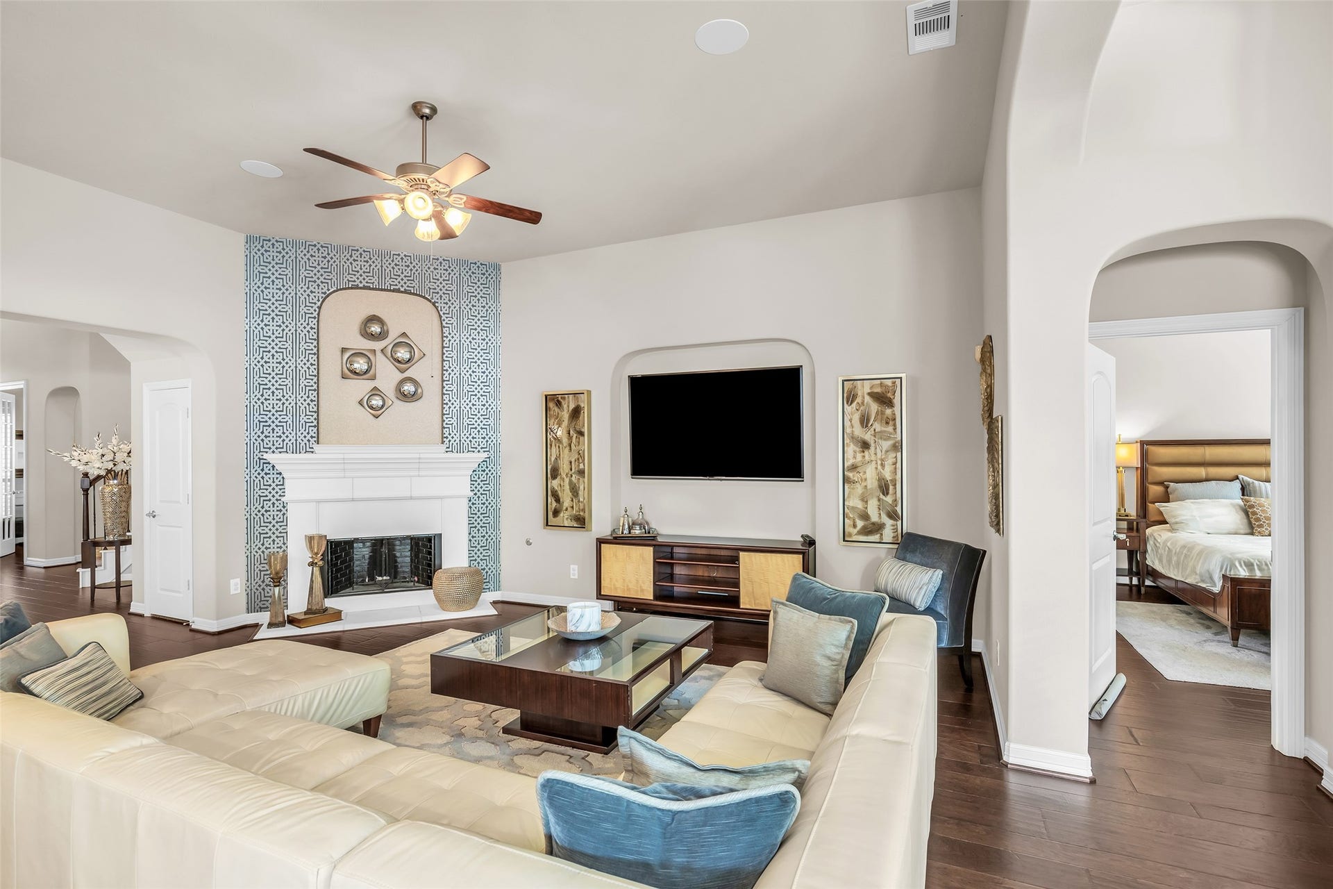 246 Hearthshire Circle, The Woodlands, TX 77354 Family room with gas fireplace and decorative mantel is adjacent to the primary bedroom