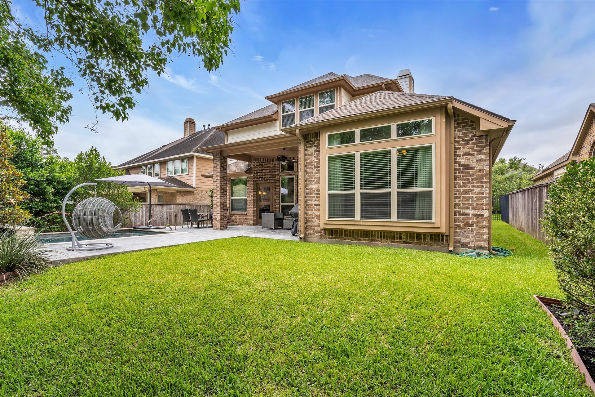 246 Hearthshire Circle, The Woodlands, TX 77354 Backyard with extended stamped concrete patio and pool decking