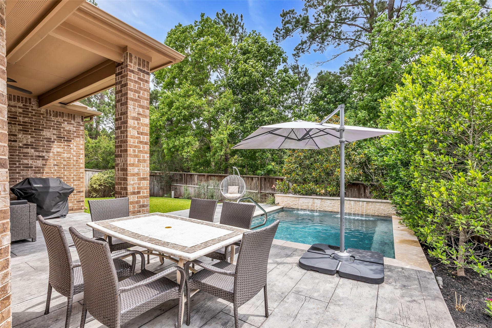 246 Hearthshire Circle, The Woodlands, TX 77354 Desirable backyard set up with no rear neighbors and gas grill connections. Pool has bubblers, colored lights and cascade waterfalls