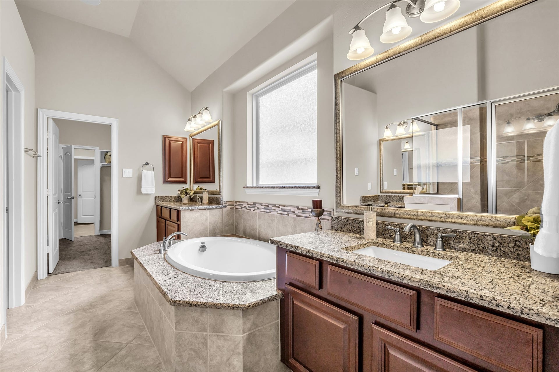 246 Hearthshire Circle, The Woodlands, TX 77354 En-suite bathroom with dual vanities plus desirable direct access to utility room from the primary closet