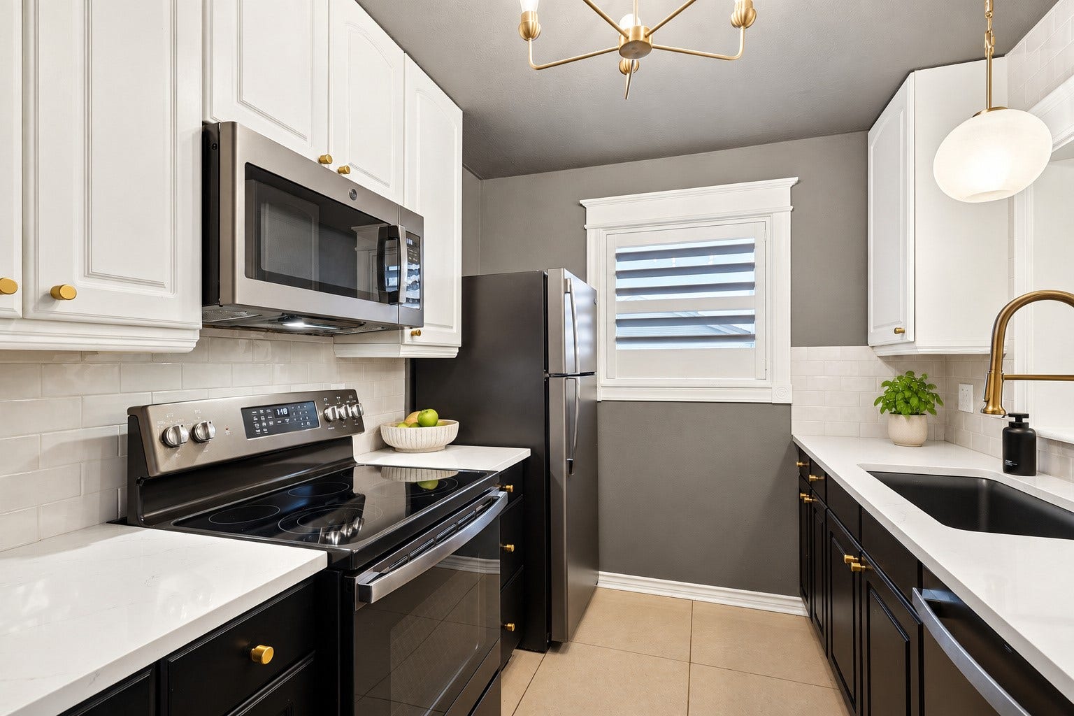This kitchen is sleek and elegant with plenty of cabinets and counter space.