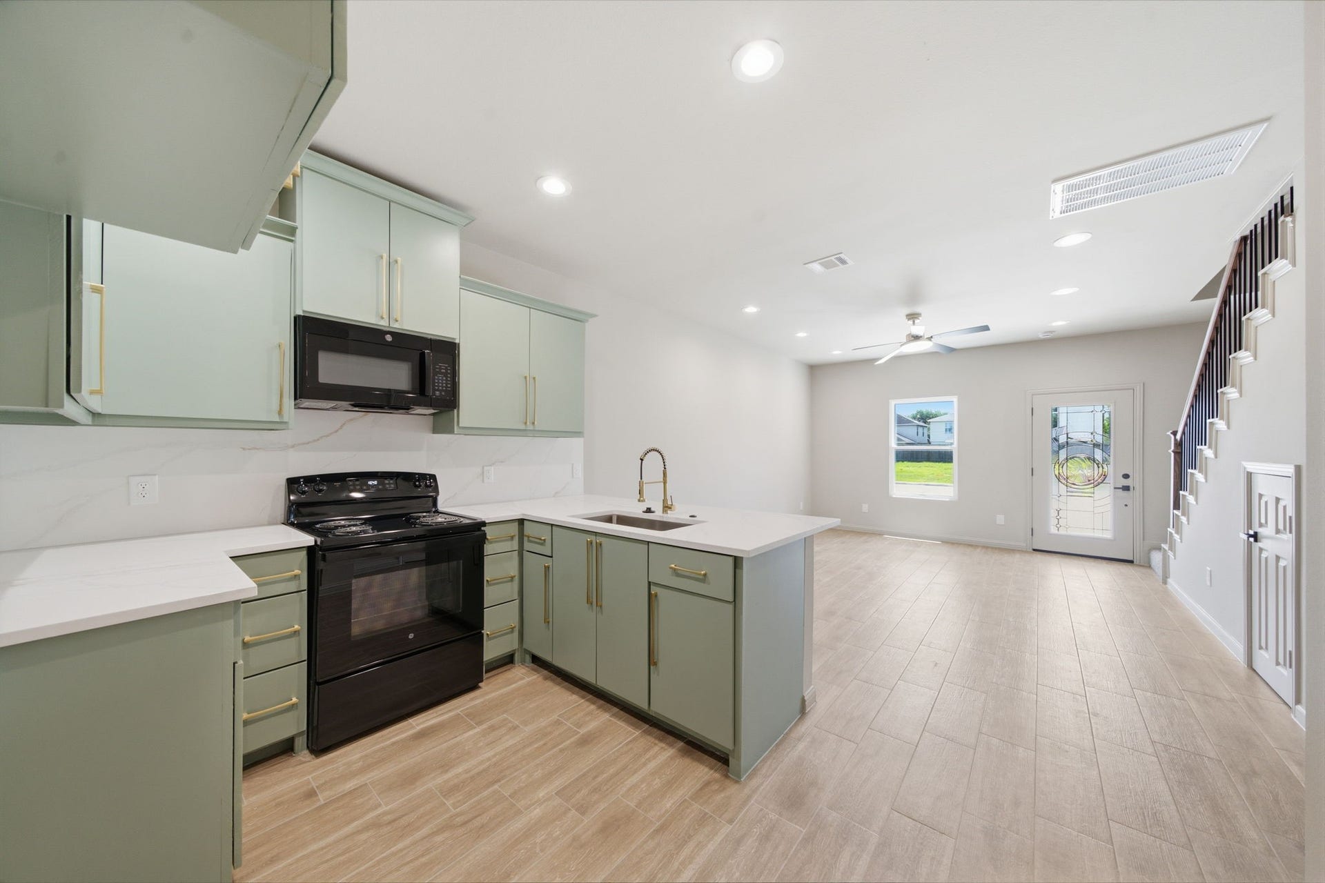 Open concept kitchen flows seamlessly into the living area, creating a bright and functional layout for everyday living and entertaining.