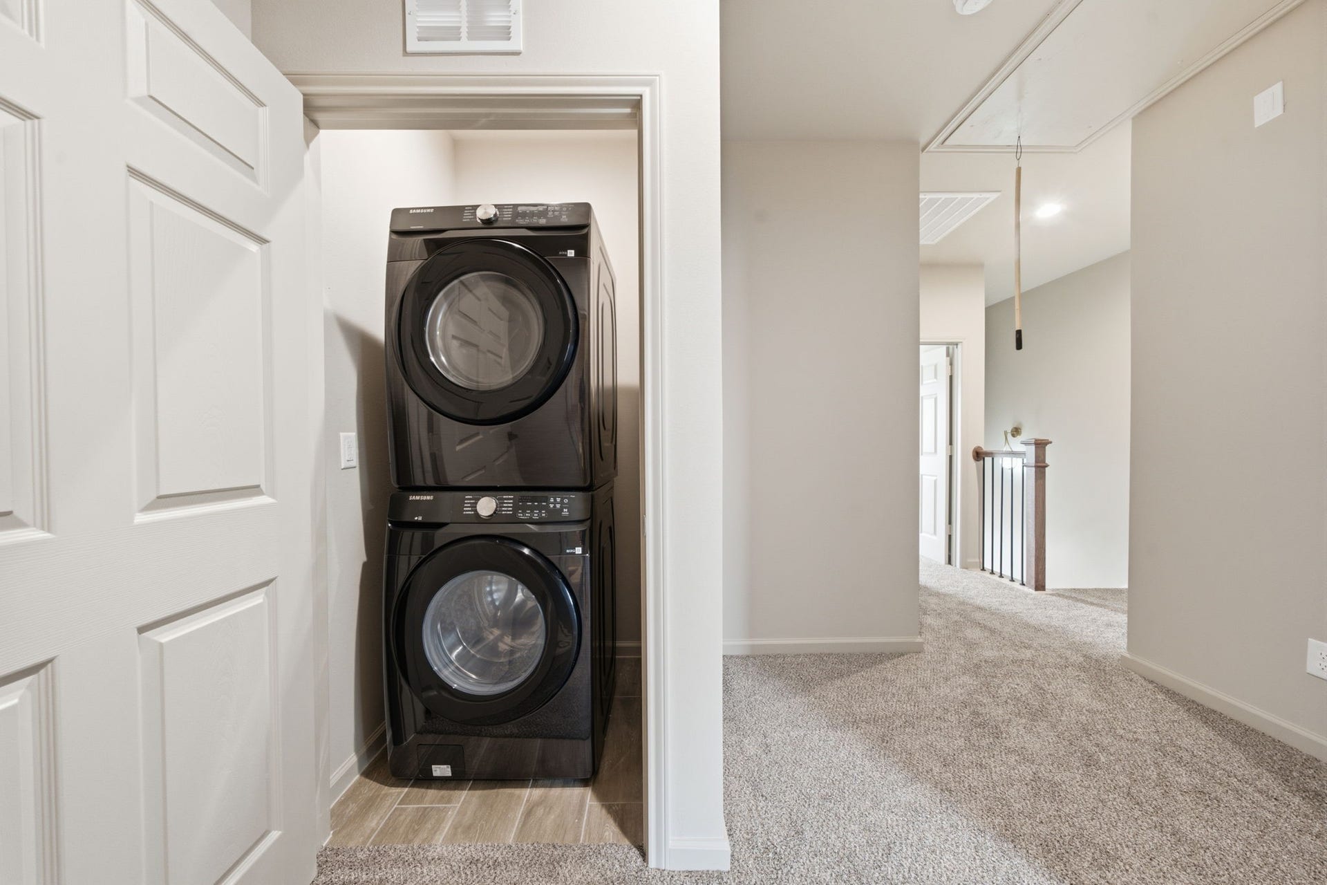 Each unit includes a dedicated upstairs laundry area with a stacked washer and dryer for everyday convenience.