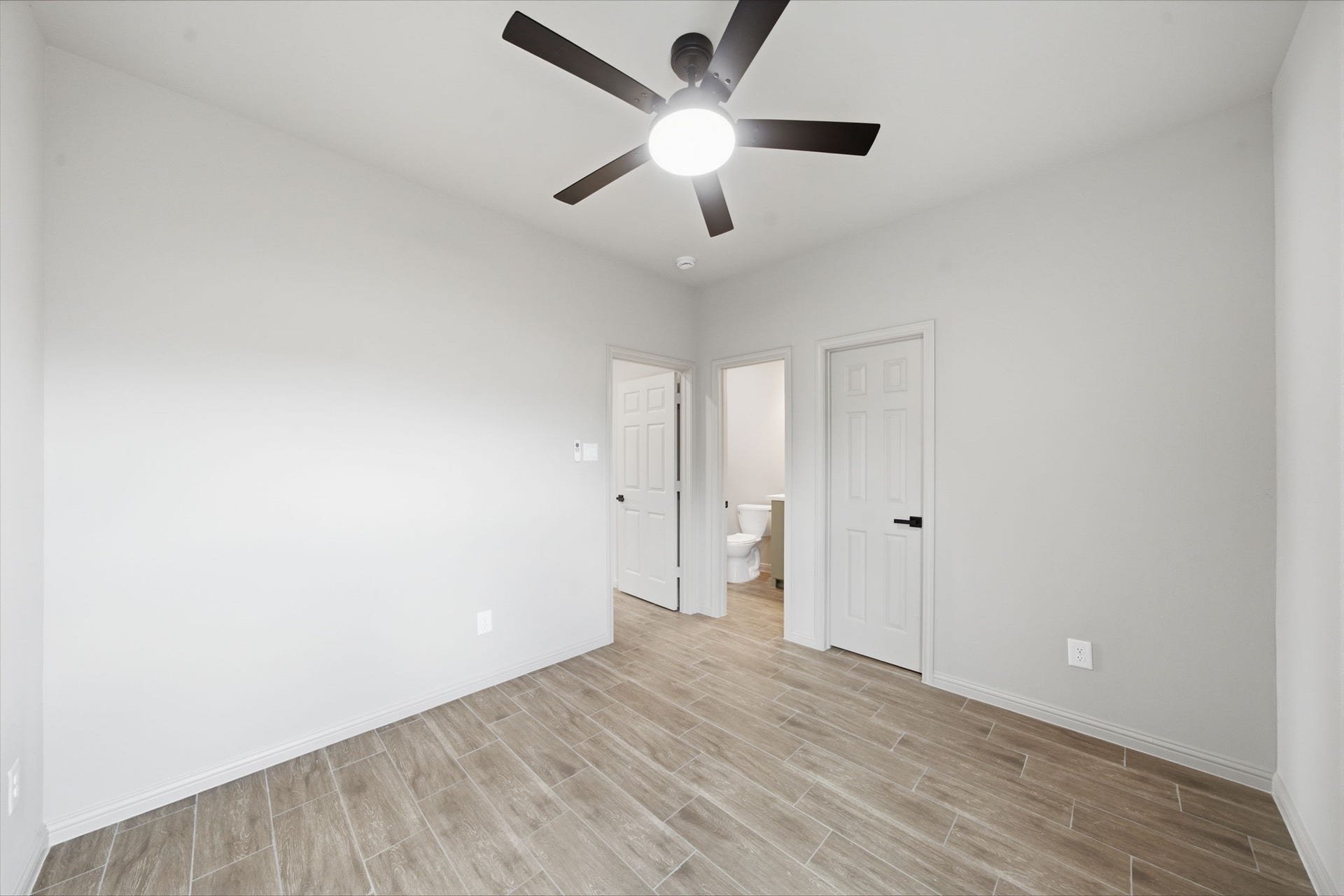 Private first floor primary suite offers an ensuite bath, modern finishes and the convenience of main-level living.