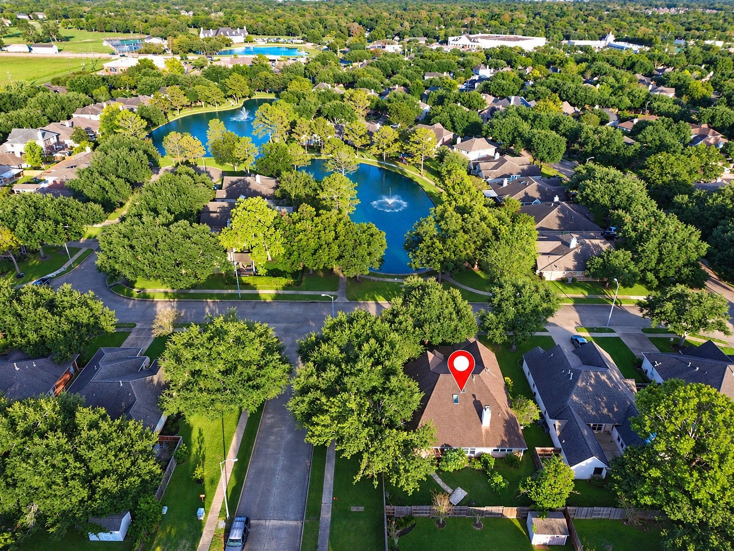 A drone shot showcasing the community and how close the pond is to the home!