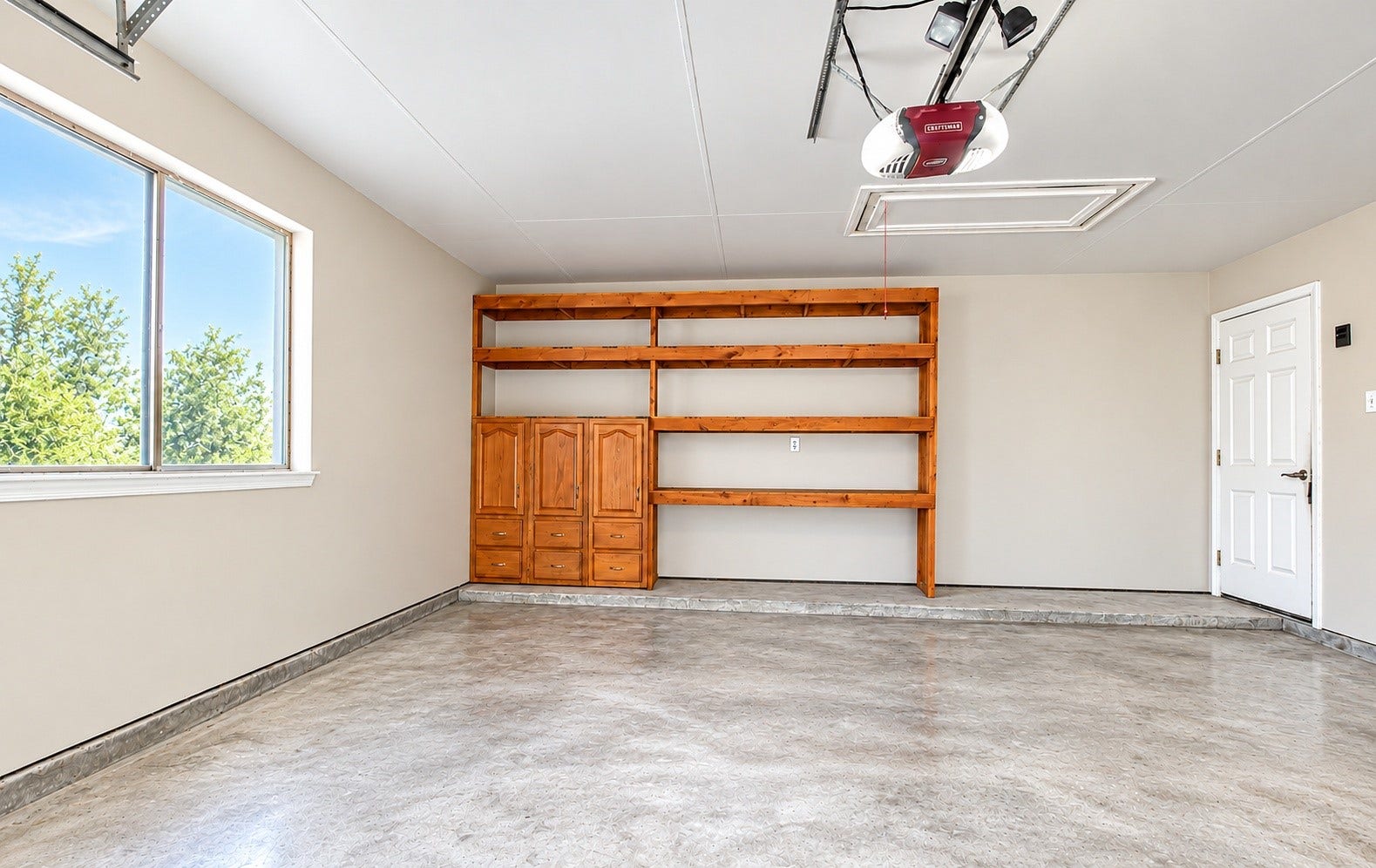 The two car garage has built-in shelves/a workshop area!