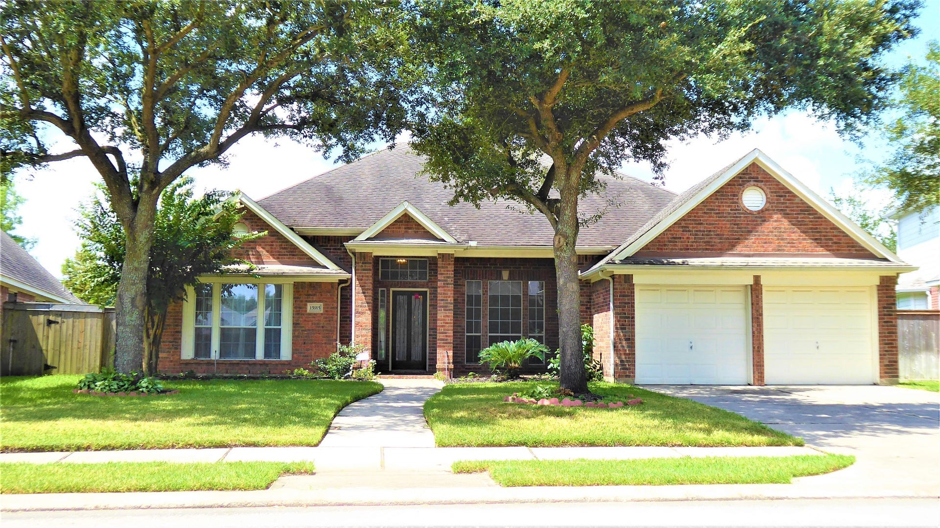 15915 Misty Heath Lane, Houston, TX 77084 Home Sweet Home, with mature live oak trees in front