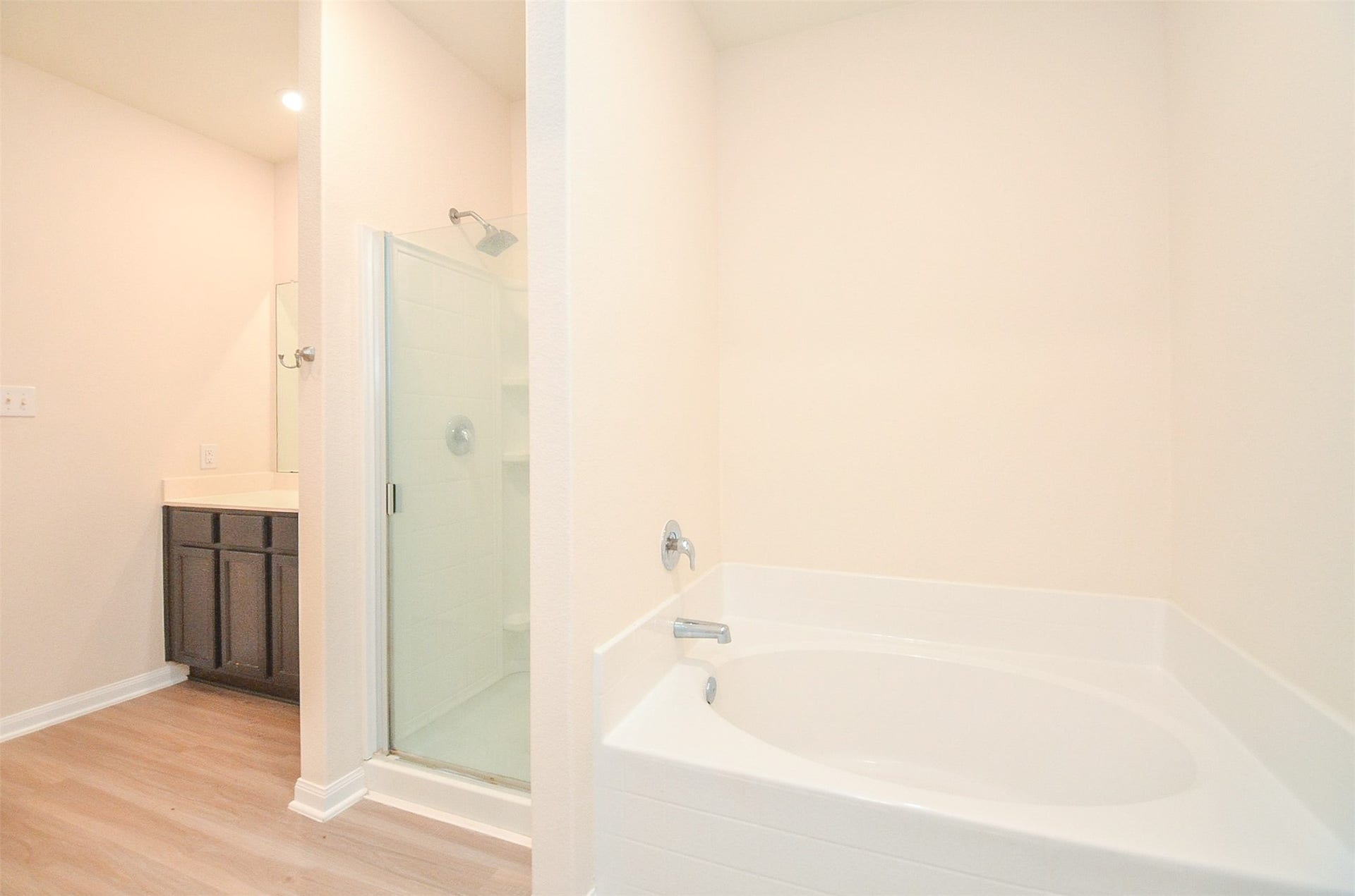 Another view of the Soak Tub and Tile Surround Shower. Luxury Vinyl Flooring and Spacious Walk-In Closet.