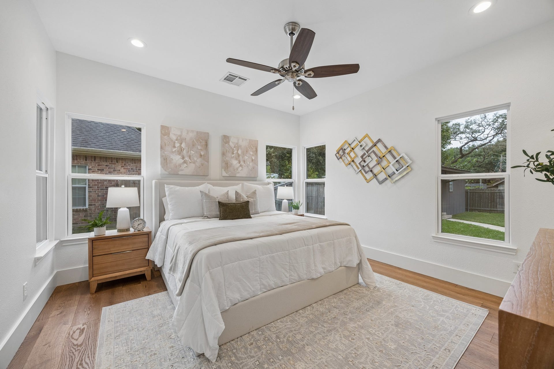 711 4th Street, Sealy, TX 77474 Primary bedroom featuring large windows offering plenty of natural light and views of the spacious backyard.