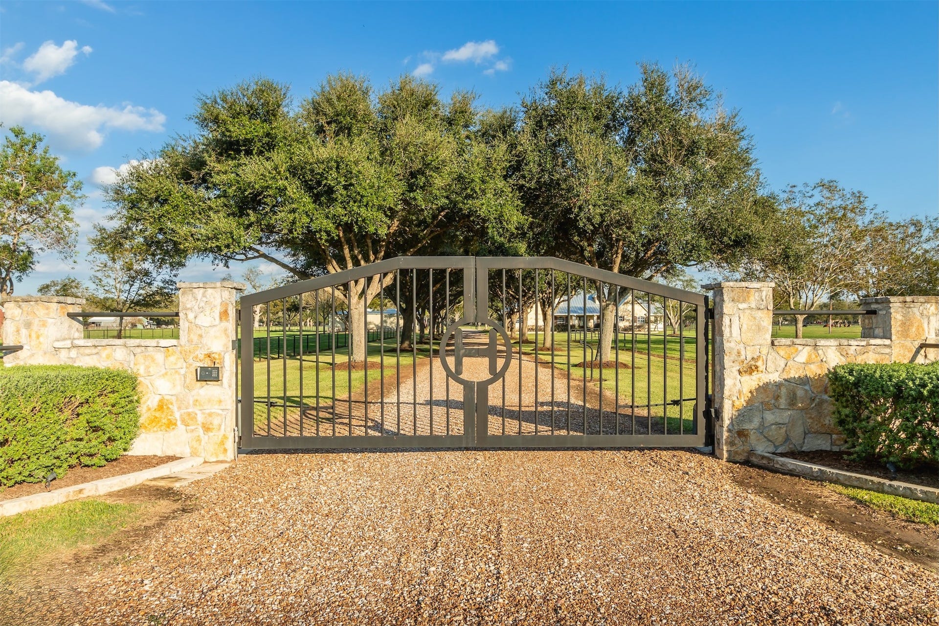 3150 Holmes Road Road, Richmond, TX 77406 Grand stone and wrought iron gate offering an elegant entrance to your private retreat.