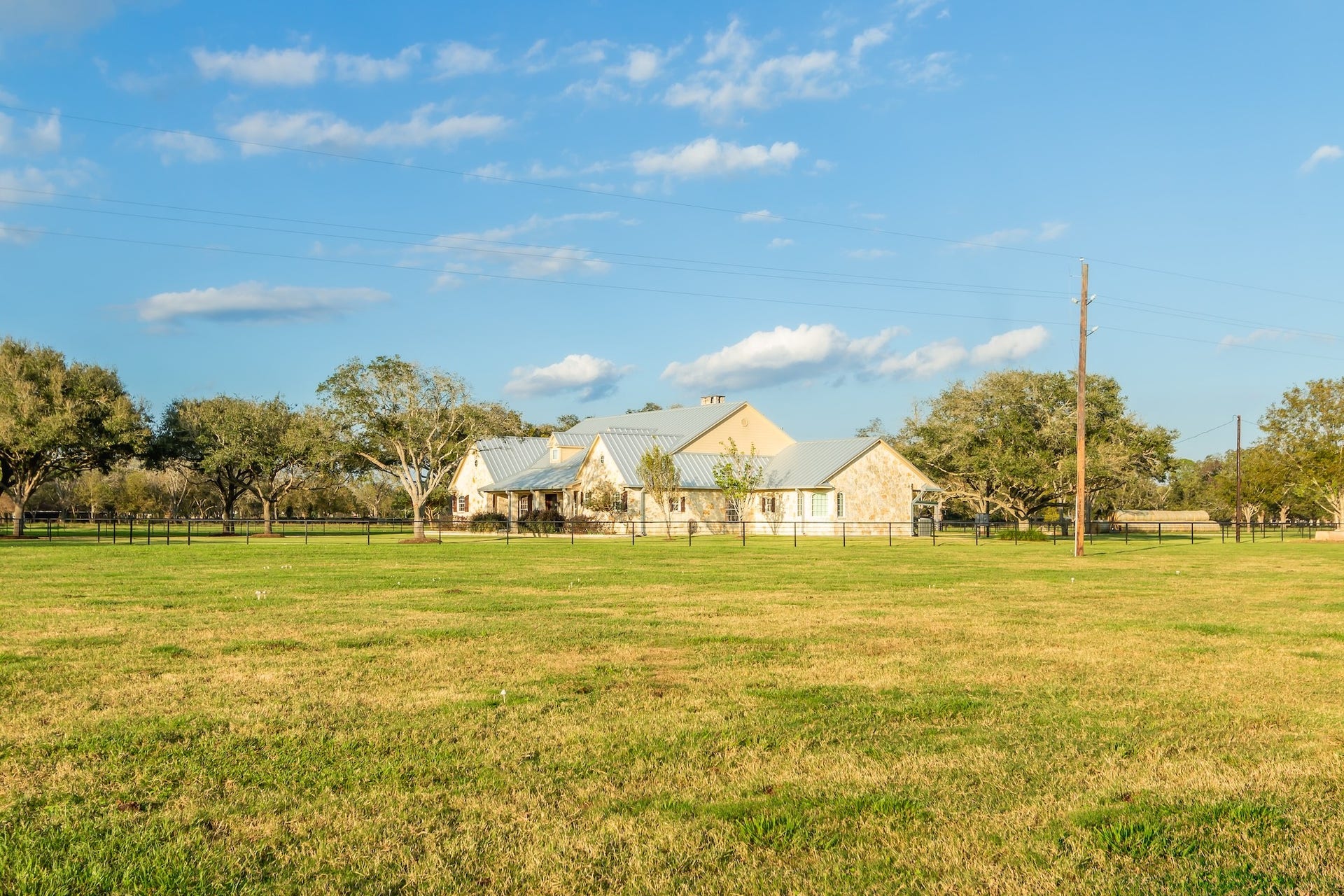 3150 Holmes Road Road, Richmond, TX 77406 Expansive country home with charming stonework, nestled amidst lush greenery and open spaces.