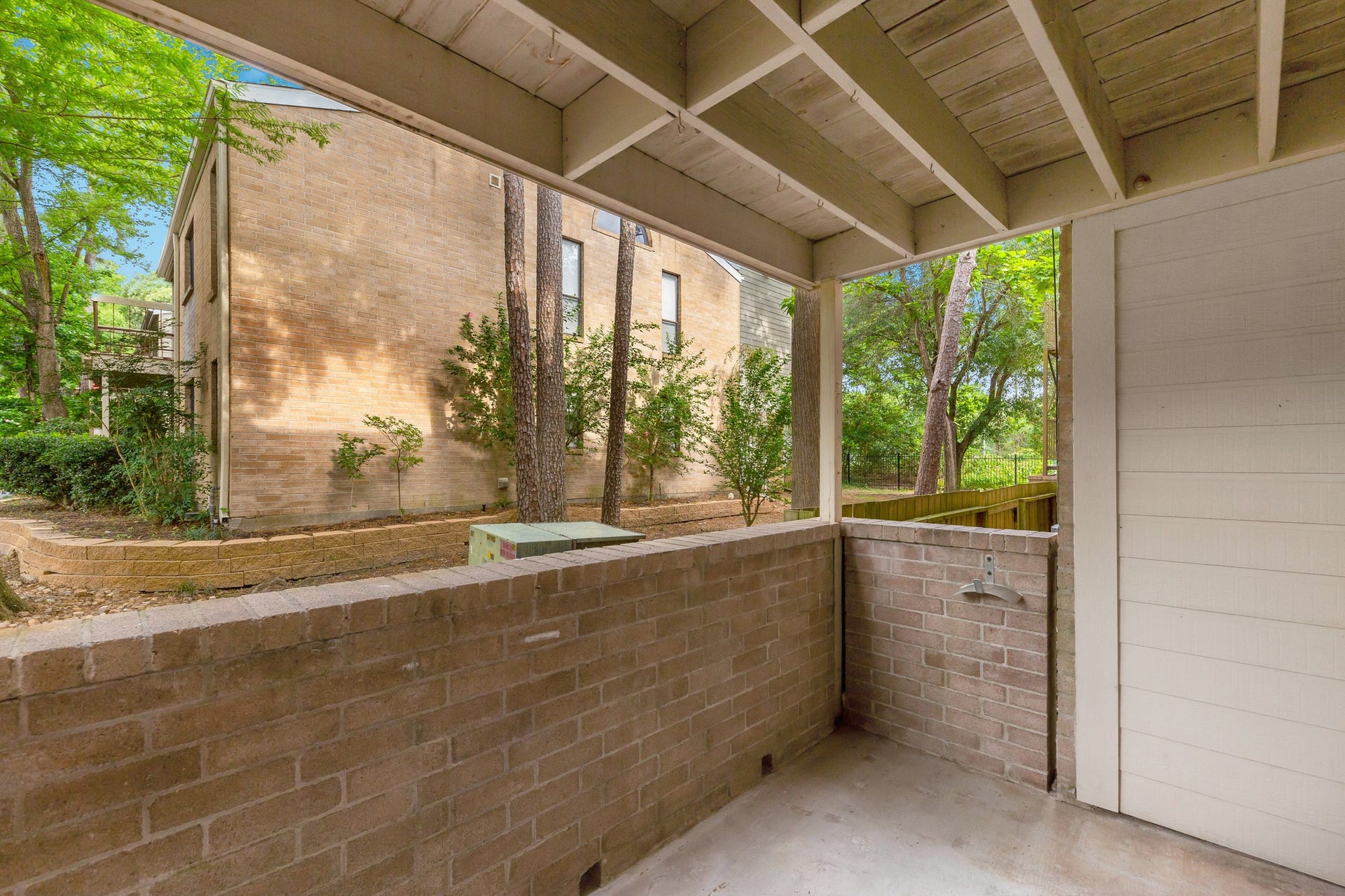 Your private patio is surrounded by a brick wall.