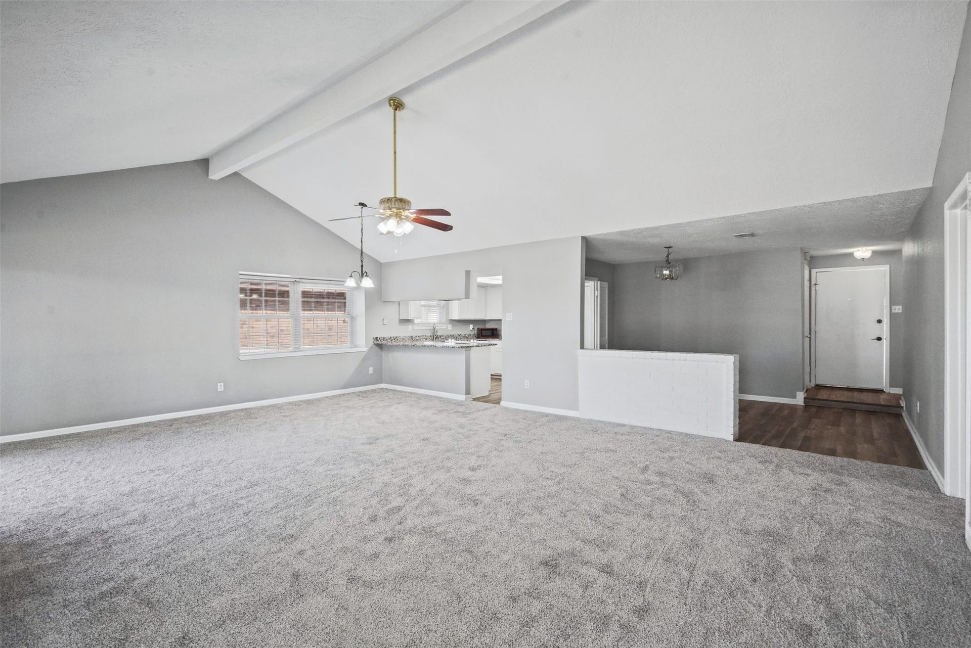 1323 Castle Glen Drive, Houston, TX 77015 Room to relax, gather, and make memories! Vaulted ceilings create an airy atmosphere, while the fireplace adds a cozy focal point to this generously sized living space.