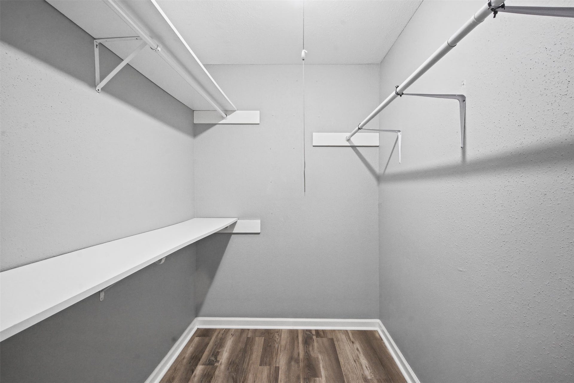 1323 Castle Glen Drive, Houston, TX 77015 Storage space you'll appreciate every day! This roomy walk-in closet features built-in shelving and hanging rods, making it easy to keep your wardrobe organized and essentials within reach.