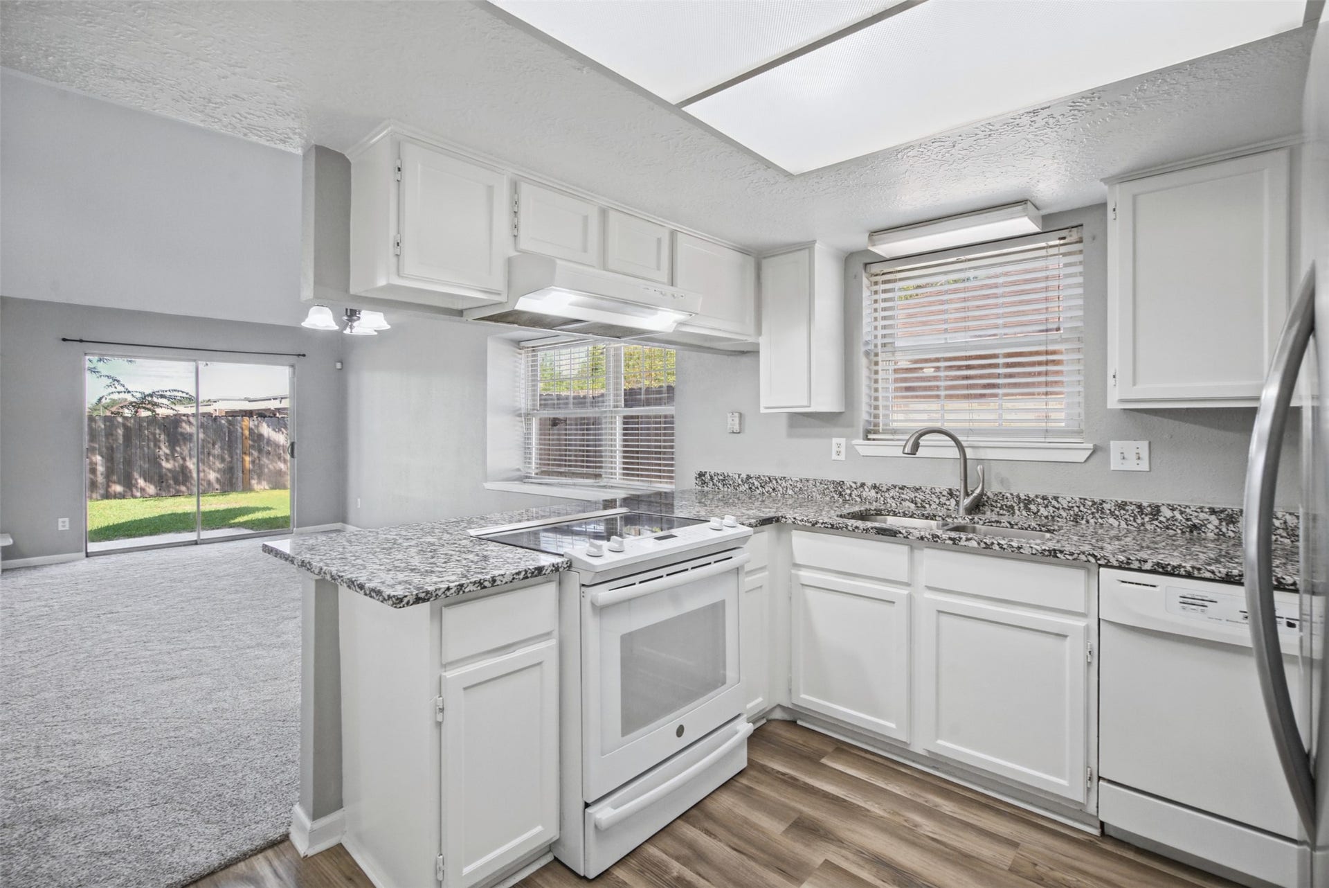 1323 Castle Glen Drive, Houston, TX 77015 A kitchen designed for everyday convenience! Featuring granite countertops, crisp white cabinetry, and a breakfast bar that makes everything from morning coffee to casual meals feel effortless.