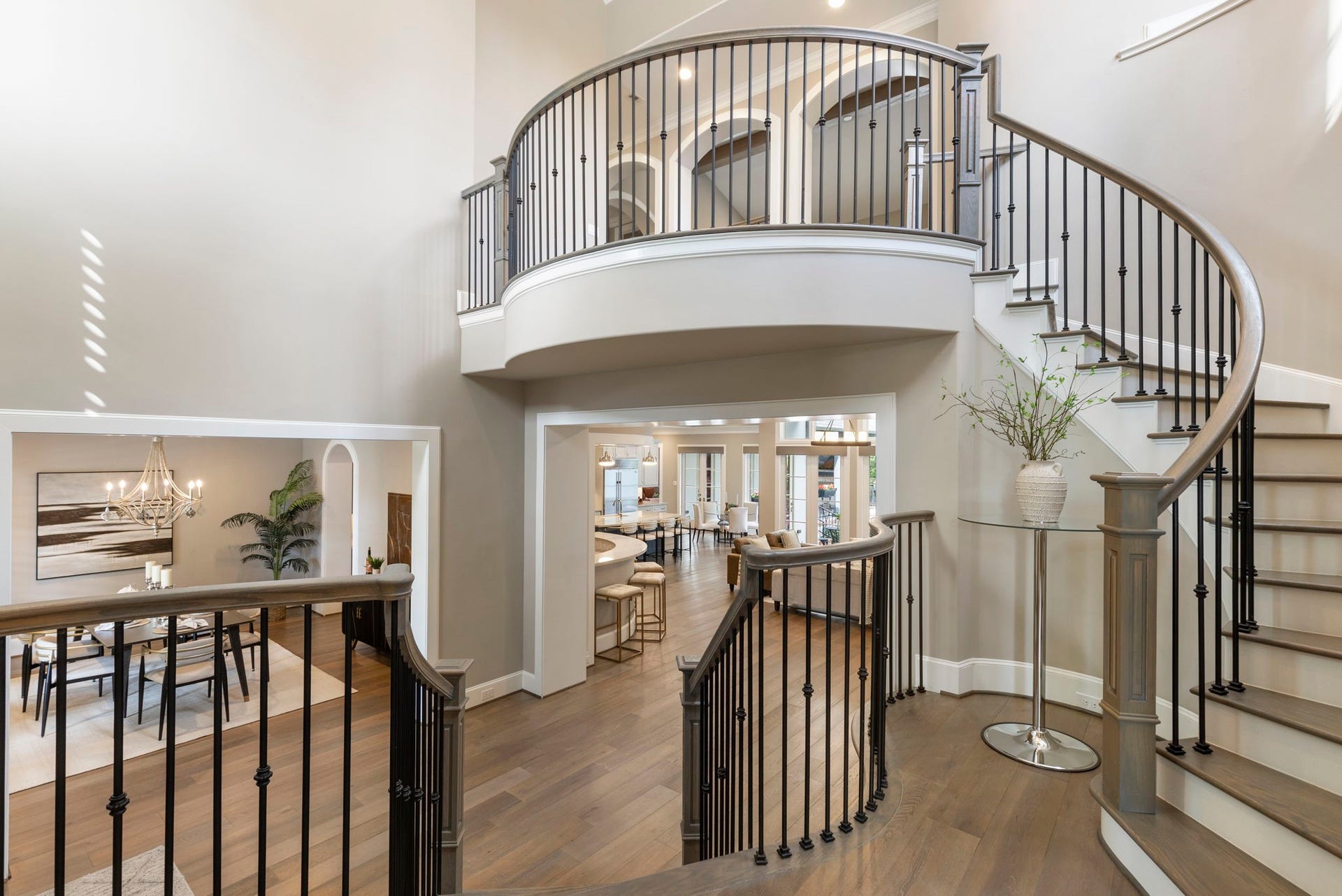 79 Simon Lake Lane, The Woodlands, TX 77381 Grand foyer showcasing soaring ceilings and an impressive open staircase.
