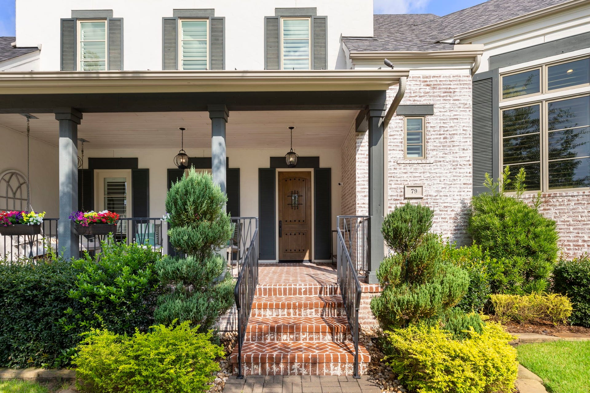 79 Simon Lake Lane, The Woodlands, TX 77381 Inviting covered front porch with brick walkway and beautiful architectural details.