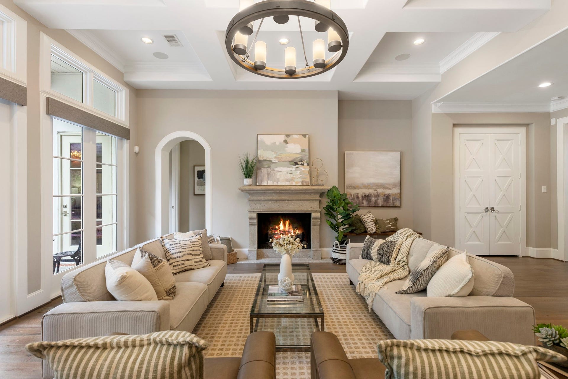 79 Simon Lake Lane, The Woodlands, TX 77381 Open-concept family room featuring a cozy fireplace and views of the backyard oasis.
