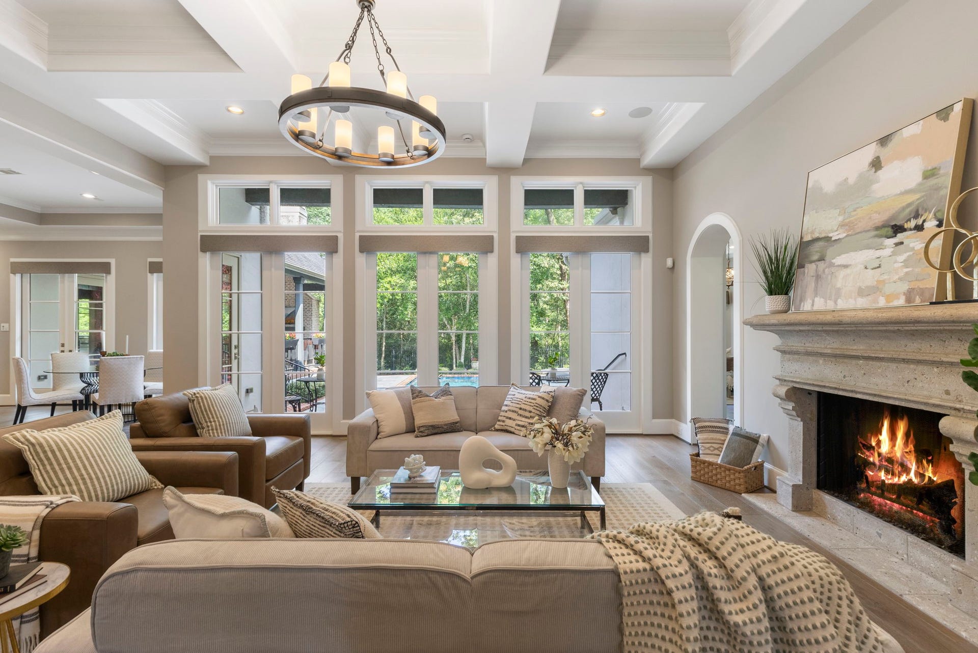 79 Simon Lake Lane, The Woodlands, TX 77381 Expansive family room with soaring ceilings, fireplace, and wall of windows.