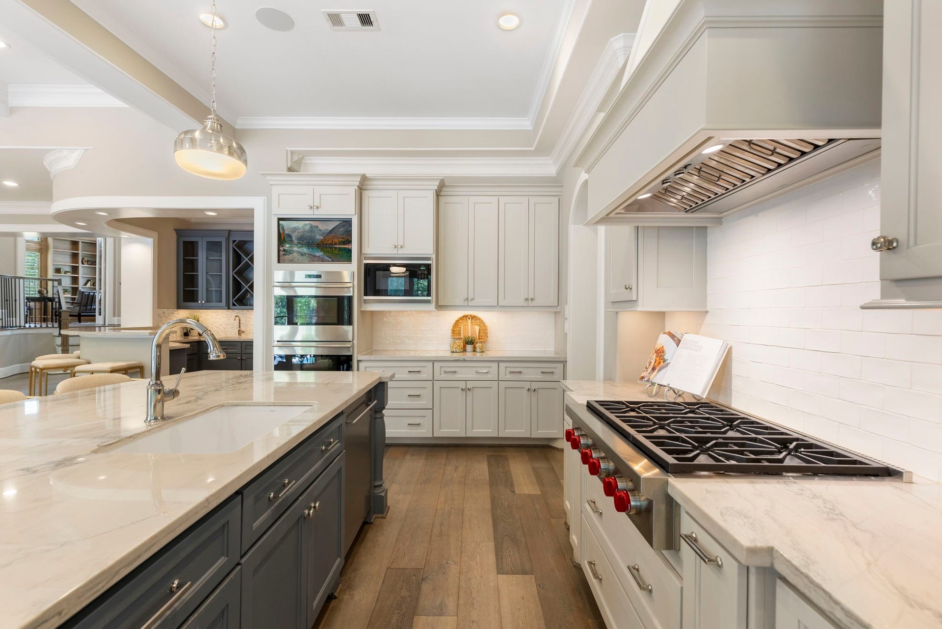 79 Simon Lake Lane, The Woodlands, TX 77381 Chef's kitchen featuring a large island, Wolf and Subzero appliances, and custom cabinetry.