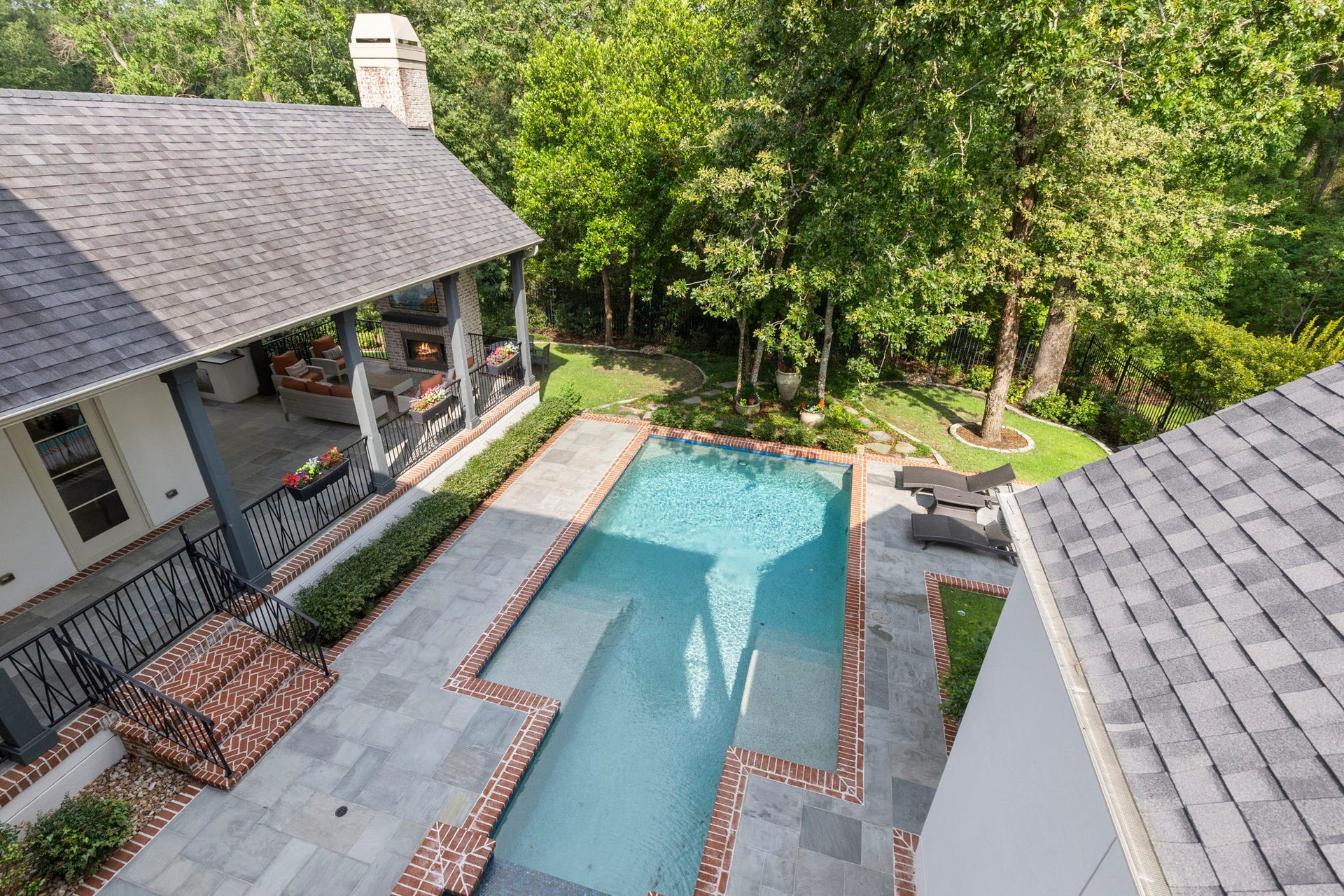 79 Simon Lake Lane, The Woodlands, TX 77381 Bird's-eye view of the backyard showcasing the pool, spa, and wooded preserve beyond.