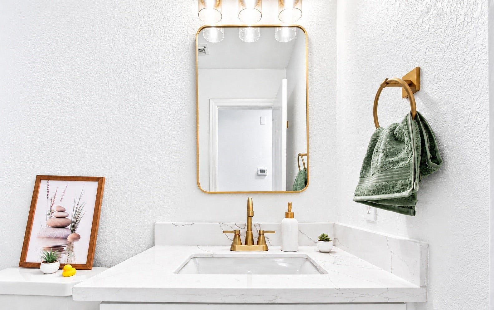 5226 Chasewood Drive, Bacliff, TX 77518 The bathroom vanity with new gold plumbing fixtures!