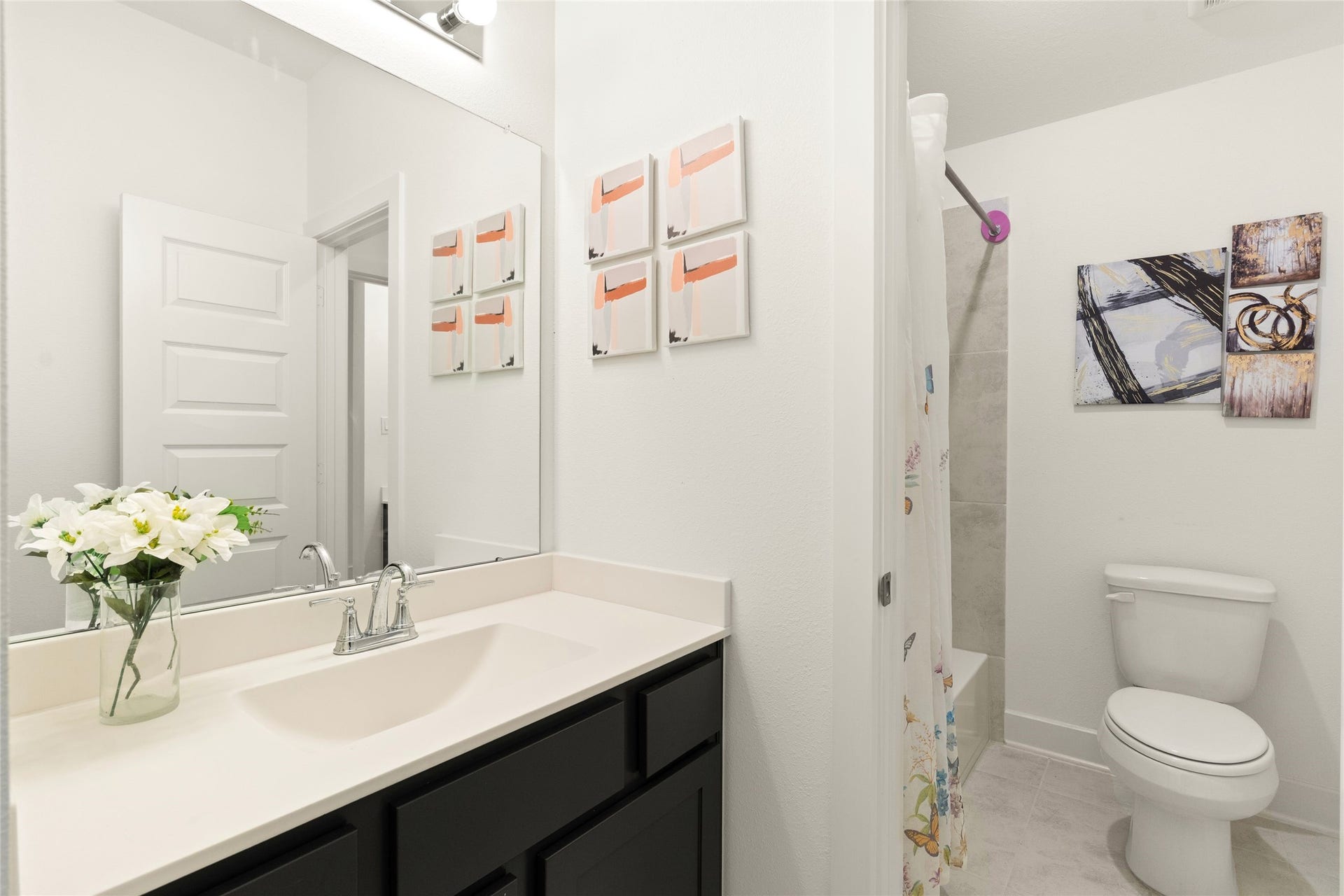 11111 Zinnias Court, Cypress, TX 77433 A secondary bathroom with a long vanity, ample storage, and a clean, timeless design.