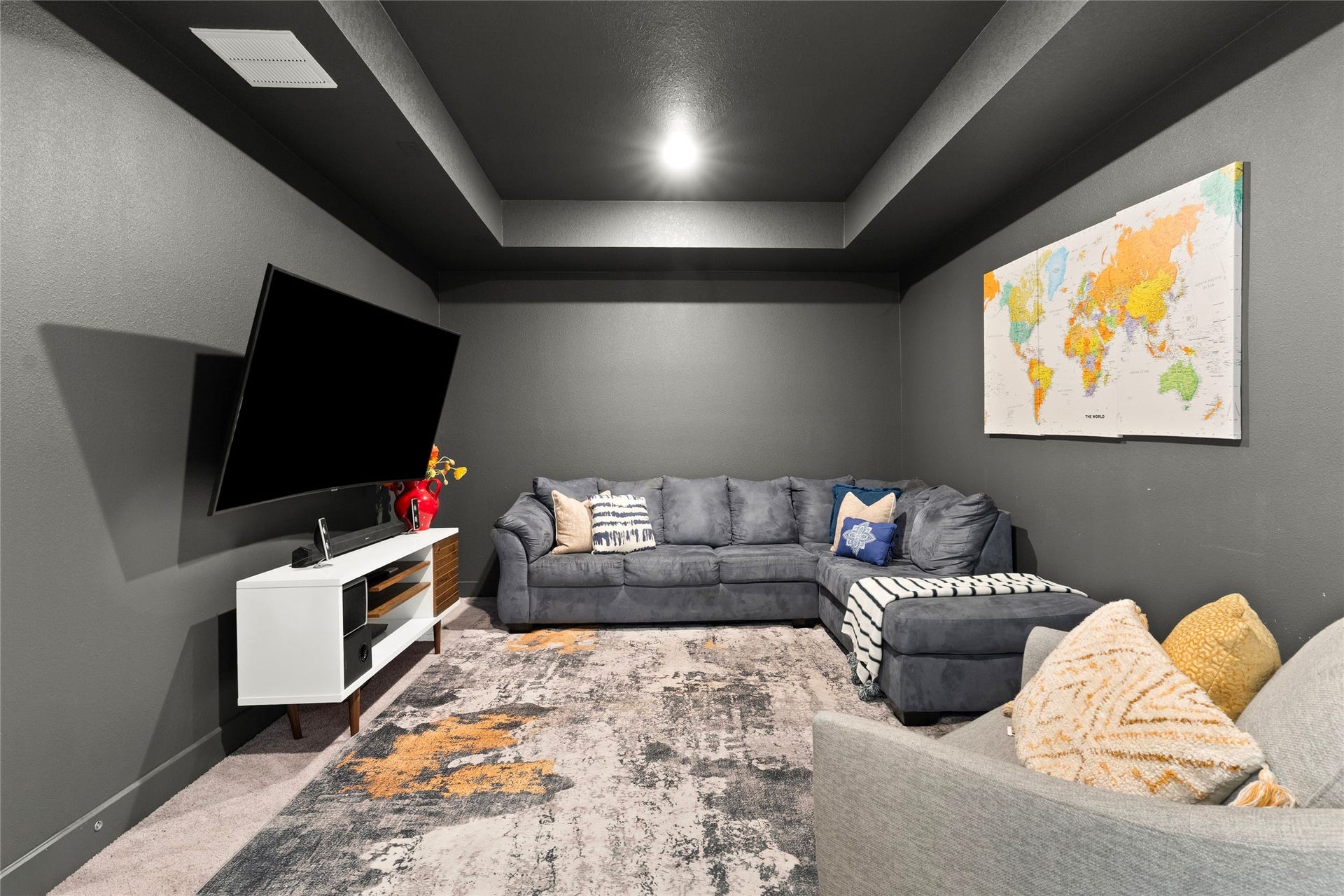 11111 Zinnias Court, Cypress, TX 77433 Dark walls, a dramatic tray ceiling, and cozy seating create an incredible media room ready for movie marathons and game-day excitement.