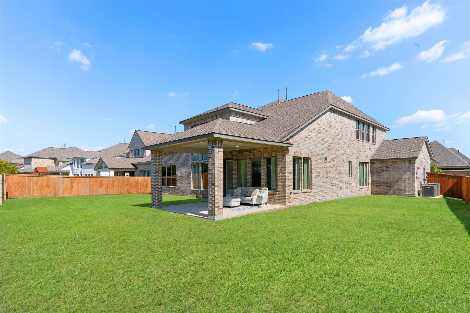 11111 Zinnias Court, Cypress, TX 77433 With an expansive lawn and covered outdoor living area, this backyard is ready for everything from weekend barbecues to relaxing afternoons.