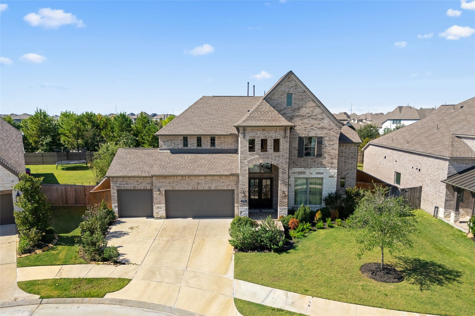 11111 Zinnias Court, Cypress, TX 77433 Even the garage gets the royal treatment! A three-car garage complete with beautiful epoxy flooring adds a polished finishing touch.