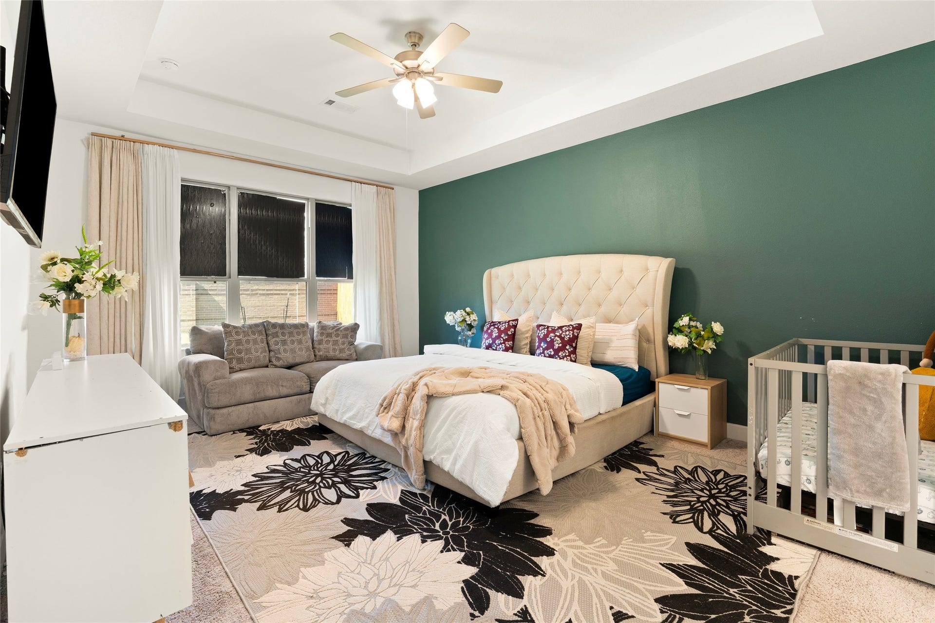 11111 Zinnias Court, Cypress, TX 77433 This gorgeous primary suite features a beautiful green accent wall, elegant ceiling detail, and plenty of room to relax at the end of the day.