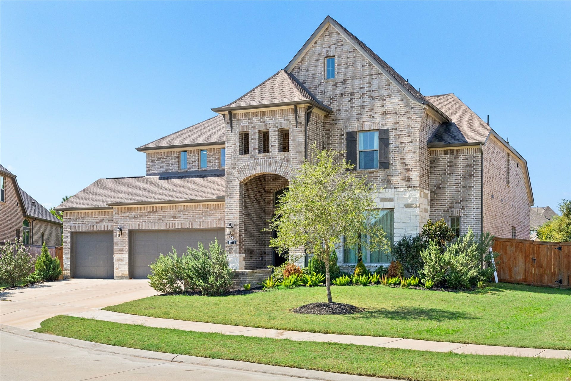 11111 Zinnias Court, Cypress, TX 77433 Beautifully manicured landscaping, striking rooflines, and timeless brickwork come together to create a picture-perfect welcome.