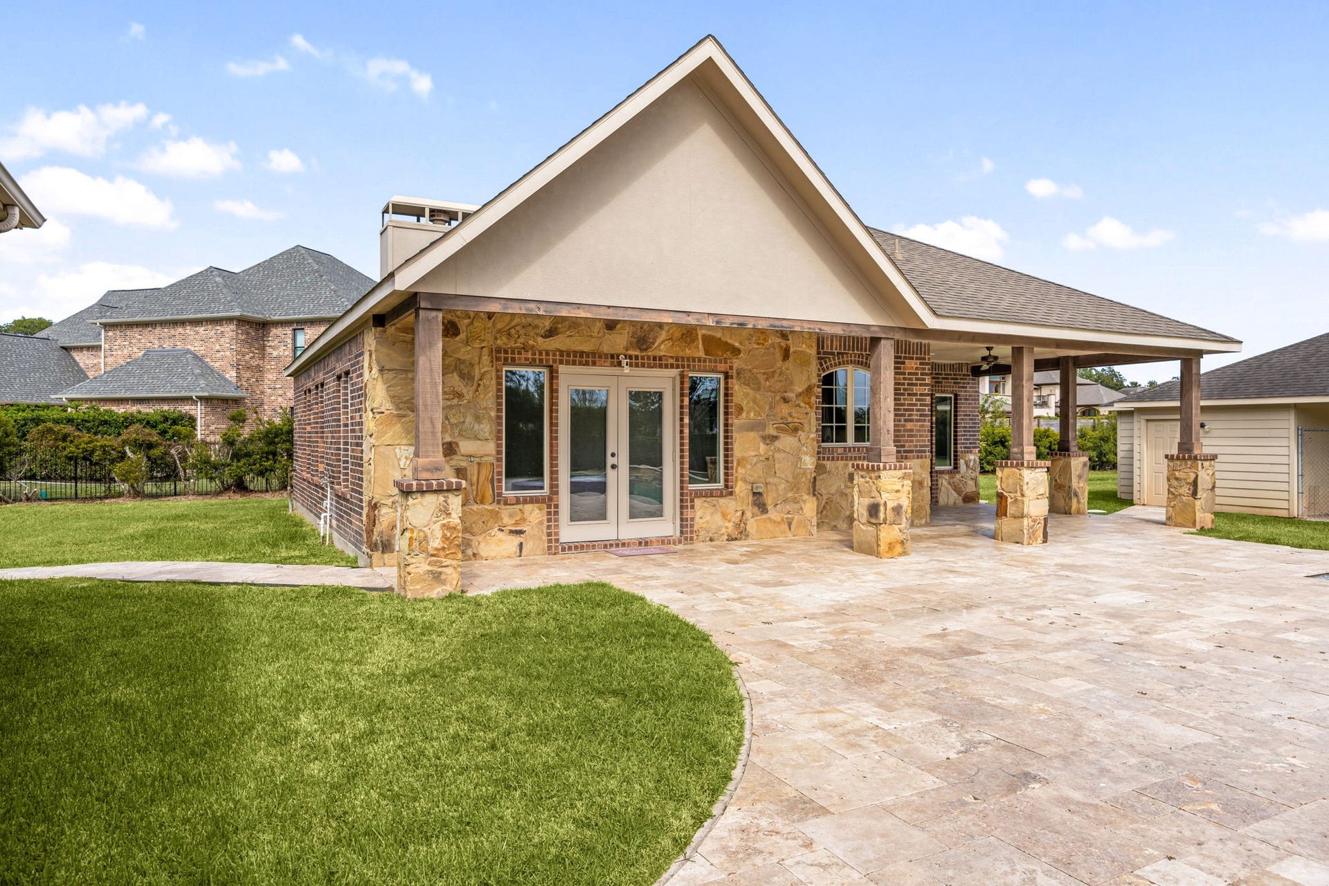 5127 Beekman Drive, Missouri City, TX 77459 The private casita is beautifully finished with stone and brick accents, a gabled roofline, and a covered patio with French doors, a true retreat of its own.