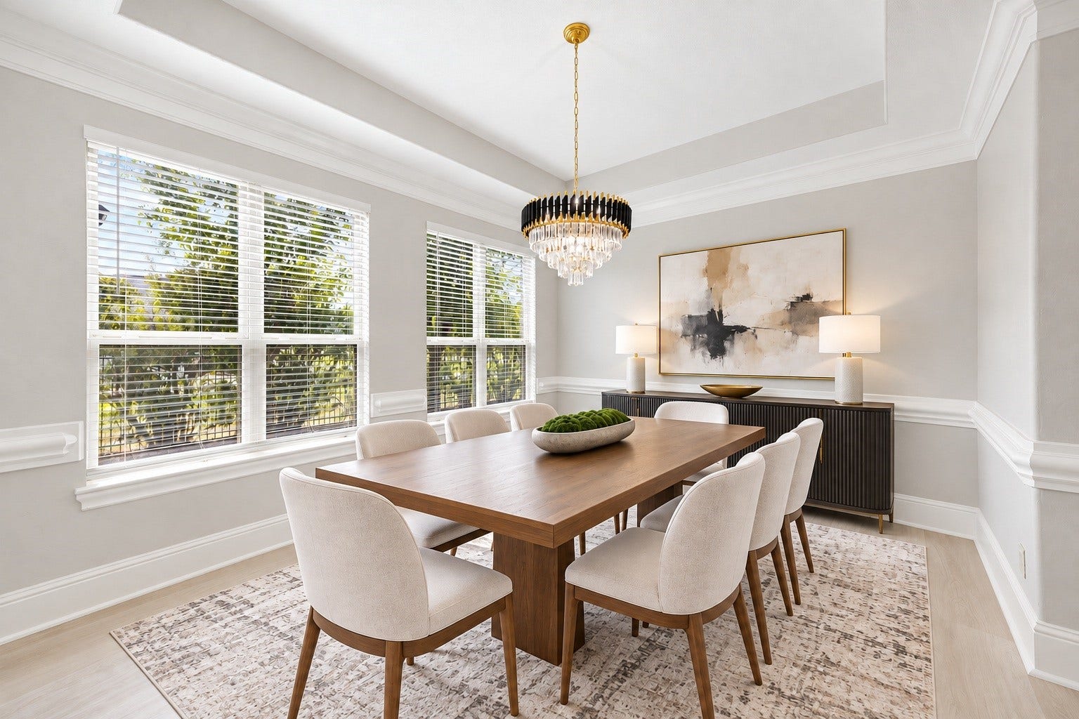 5127 Beekman Drive, Missouri City, TX 77459 A formal dining area is framed by large windows, a tray ceiling, and an elegant chandelier, offering a bright and sophisticated space for entertaining. Virtually staged.