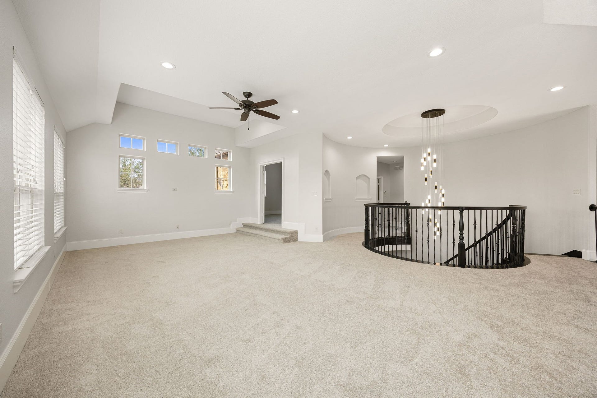 5127 Beekman Drive, Missouri City, TX 77459 A striking curved staircase and statement chandelier anchor this second level of the gameroom, adding architectural elegance to this impressive entertaining space.