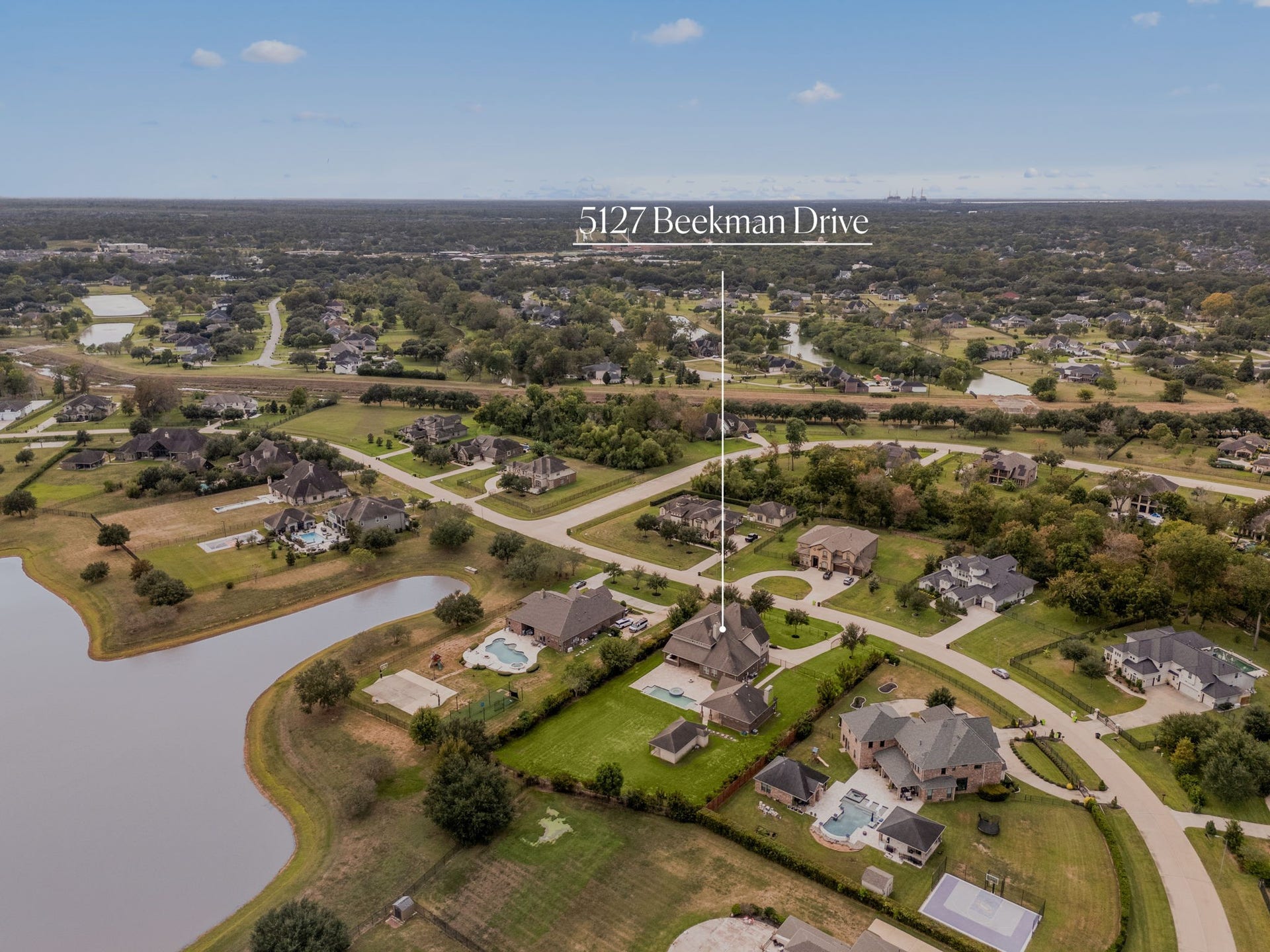5127 Beekman Drive, Missouri City, TX 77459 This view showcases the homes prime positioning within the community, with easy access to the neighborhoods scenic lake and surrounding green space.