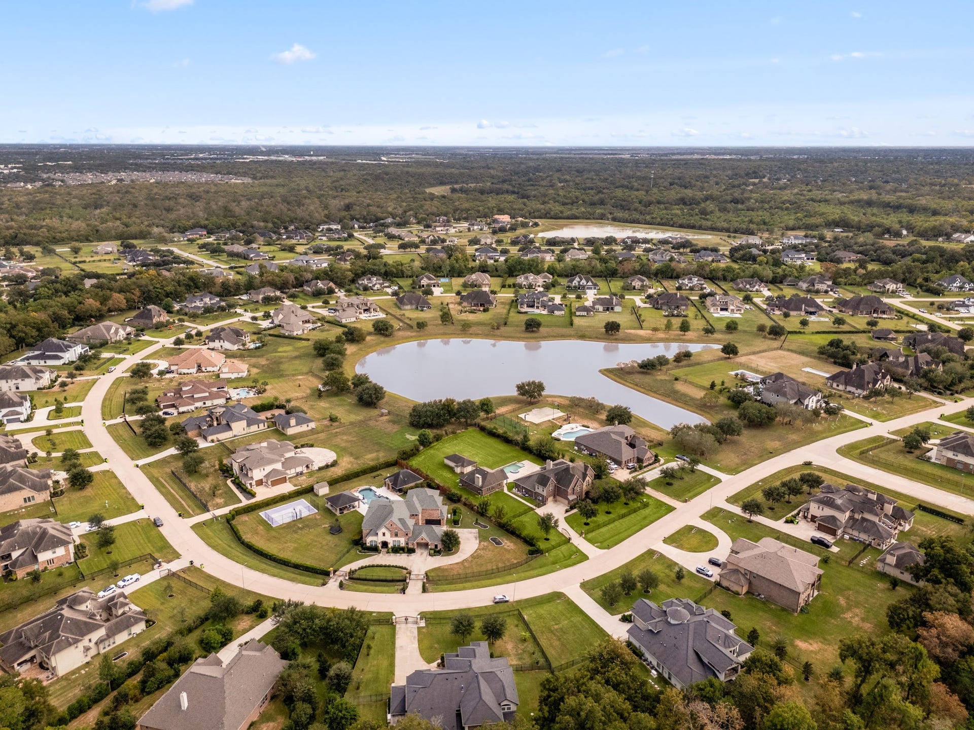 5127 Beekman Drive, Missouri City, TX 77459 This aerial view showcases the sheer scale of the property and its private, acre-plus lot, set within the established Manors at Silver Ridge community.