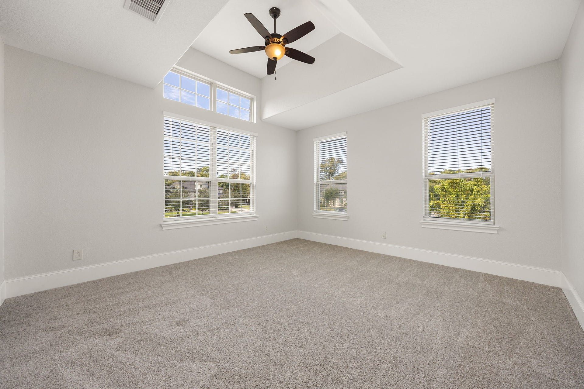 5127 Beekman Drive, Missouri City, TX 77459 The fourth bedroom impresses with a ceiling fan and oversized windows that frame picturesque views of the community.
