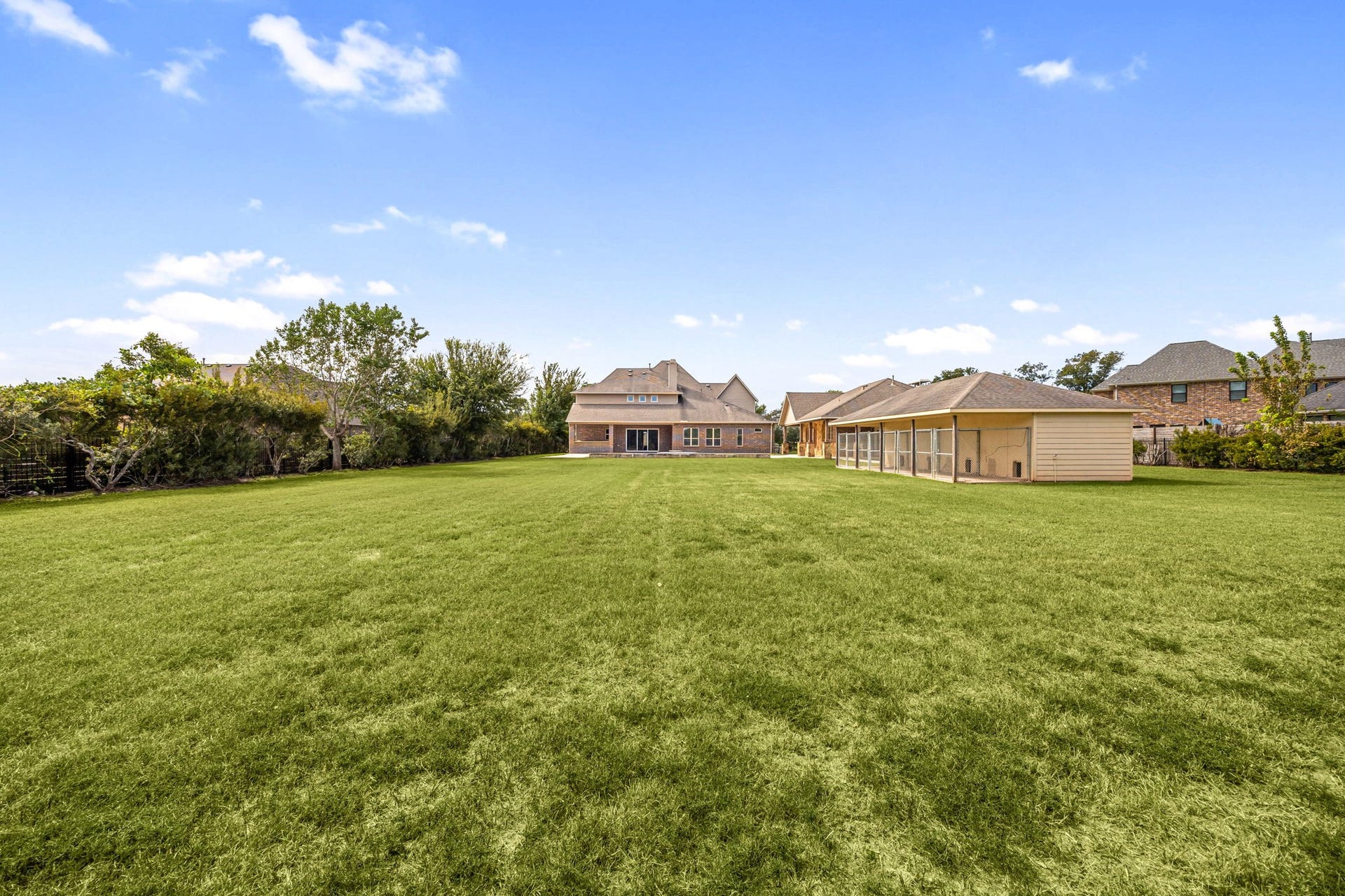 5127 Beekman Drive, Missouri City, TX 77459 A sweeping lawn stretches across the private, acre-plus lot, offering endless possibilities for outdoor recreation and entertaining.
