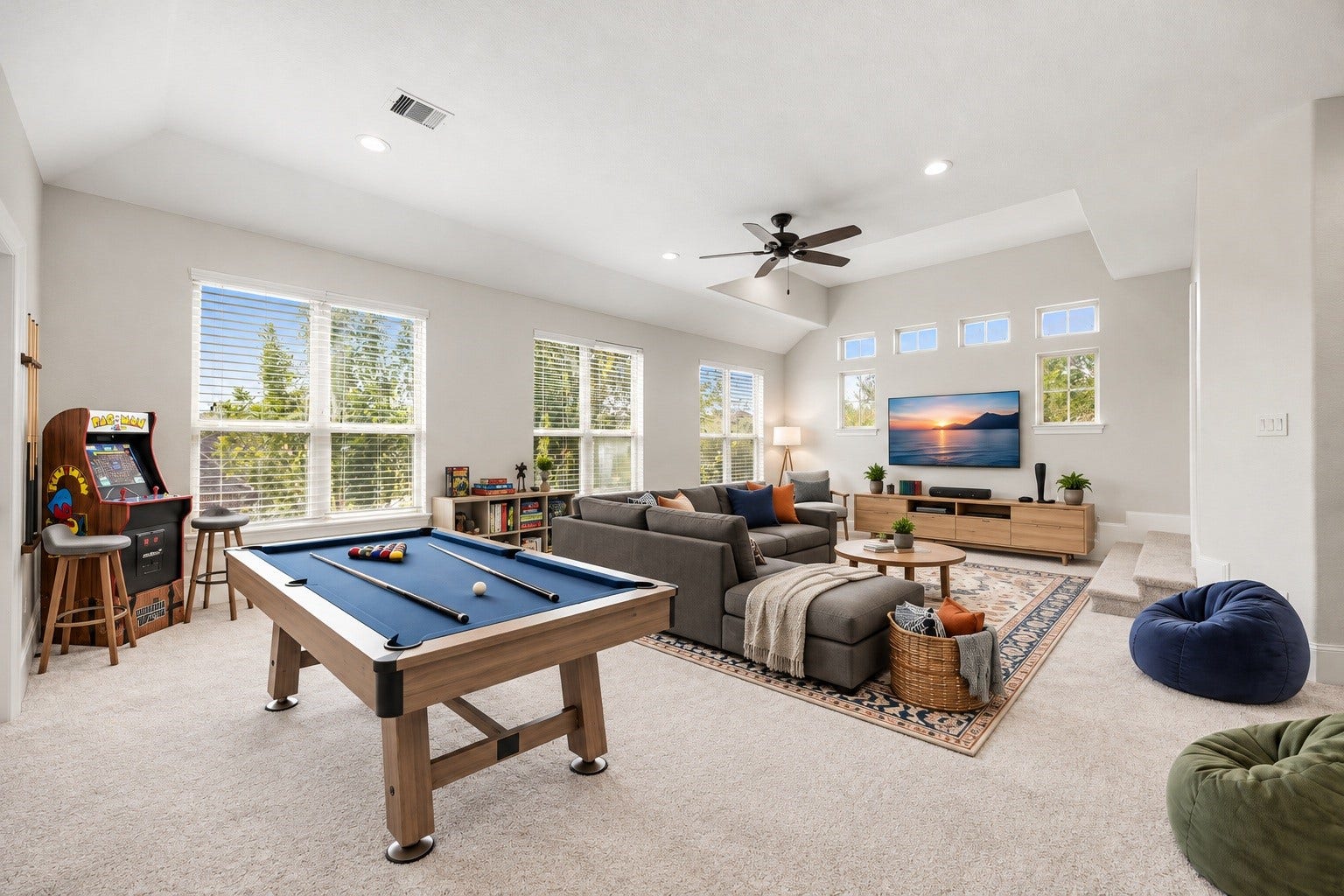 5127 Beekman Drive, Missouri City, TX 77459 The expansive upstairs gameroom offers soaring ceilings and an abundance of natural light through a wall of windows, generous space for a pool table, lounge seating, or a private retreat of your own design. Virtually staged.