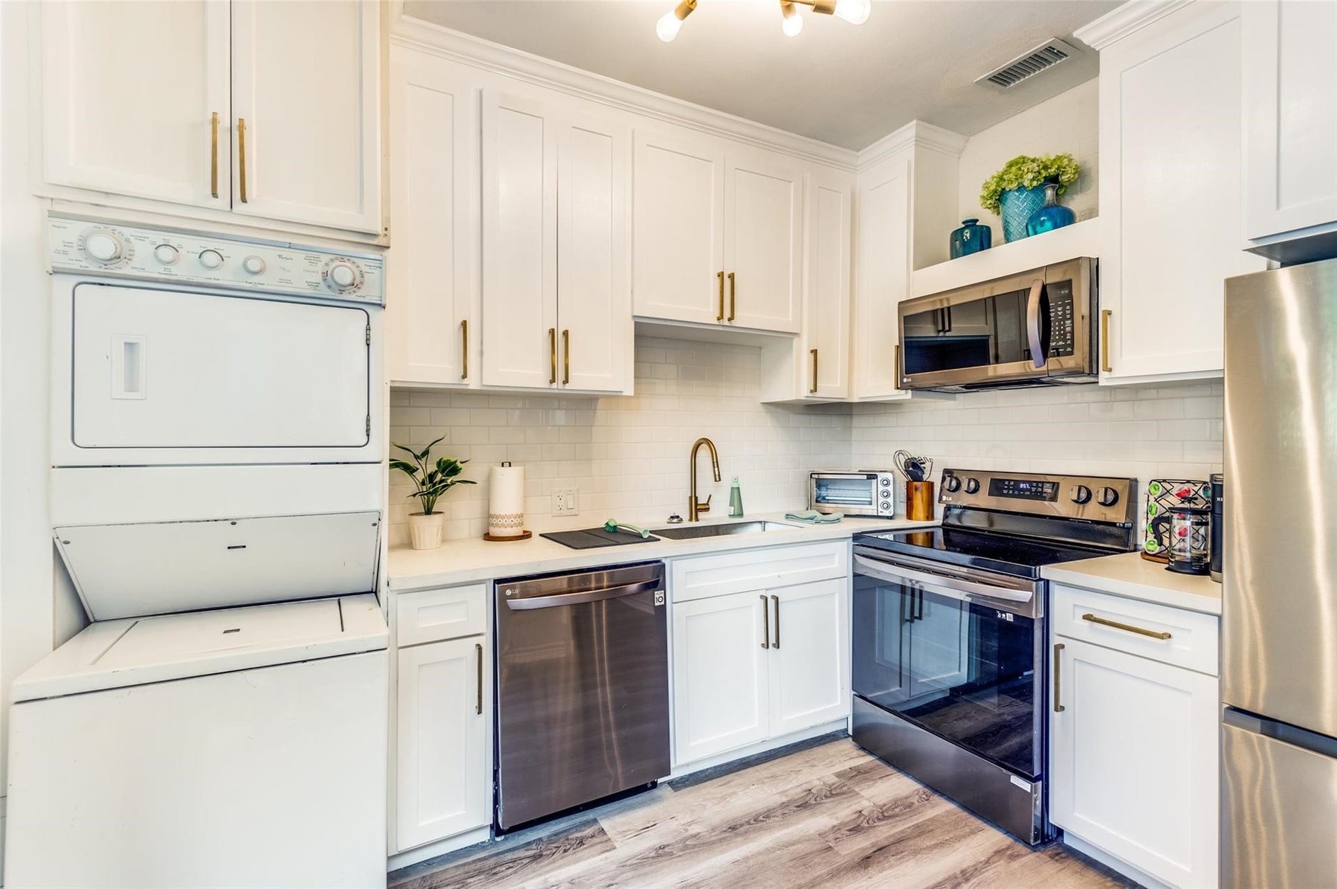 2410 Truxillo Street, #Unit C, Houston, TX 77004 Updated Kitchen with white cabinetry and stainless steel appliances
