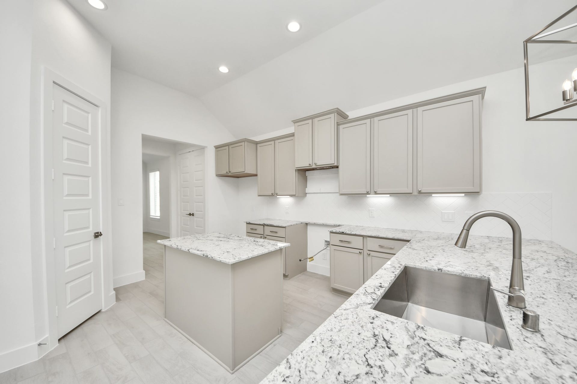 The open concept effortlessly connects the kitchen to the expansive family room, forming a perfect hub for gatherings. This seamless flow creates an inviting space where cooking and socializing come together harmoniously. Sample photo of completed home with similar floor plan. Actual colors and selections may vary.