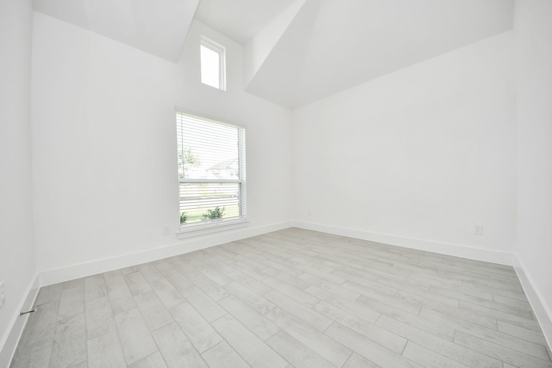 Step into the inviting home office, where elegant tile flooring adds a touch of freshness and comfort to the workspace. Natural light pours through the window, creating an inspiring environment for productivity and focus. Sample photo of completed home with similar floor plan. Actual colors and selections may vary.