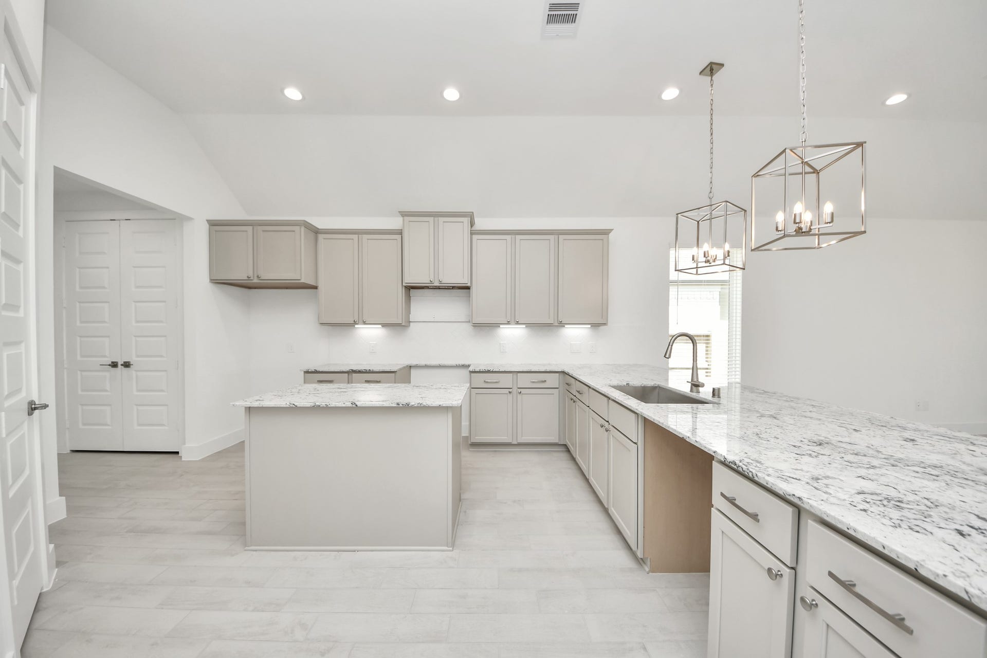 The kitchen is a culinary haven, featuring granite countertops, a tile backsplash, stainless steel appliances, 42 upper cabinets, and undercabinet lighting. Sample photo of completed home with similar floor plan. Actual colors and selections may vary.