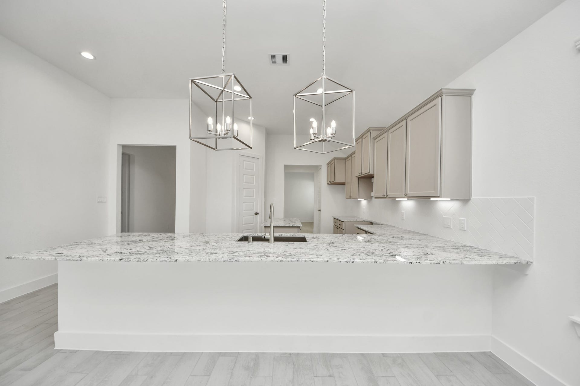 The extended counter area adds both practicality and style, making meal preparation a breeze. Every detail is thoughtfully designed to enhance the kitchen's functionality and aesthetic appeal. Sample photo of completed home with similar floor plan. Actual colors and selections may vary.