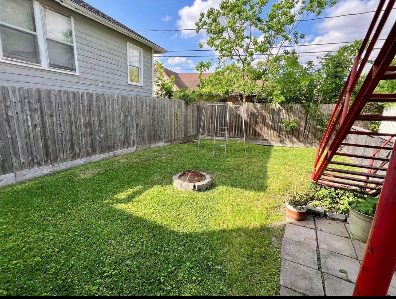 The spacious backyard is fully fenced with plenty of room for activities.