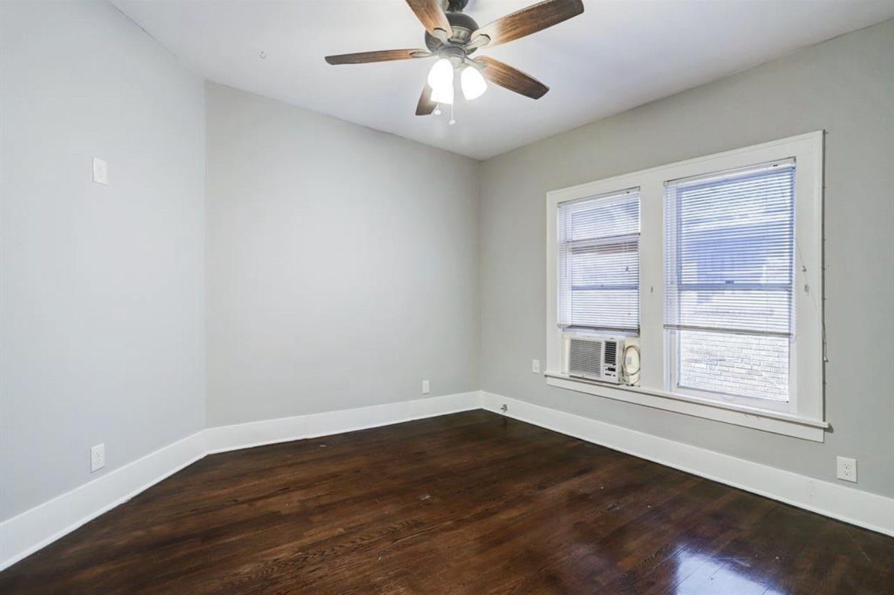 The bedrooms are large and have hardwood floors and window units.
