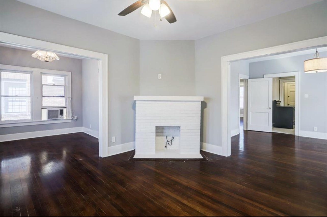 The units have spacious living rooms with a fireplace accent and hardwood floors throughout.